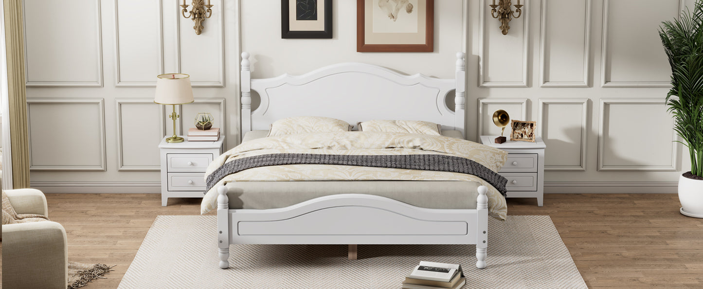 White wooden fourposter bed with ornate headboard and decorative carvings