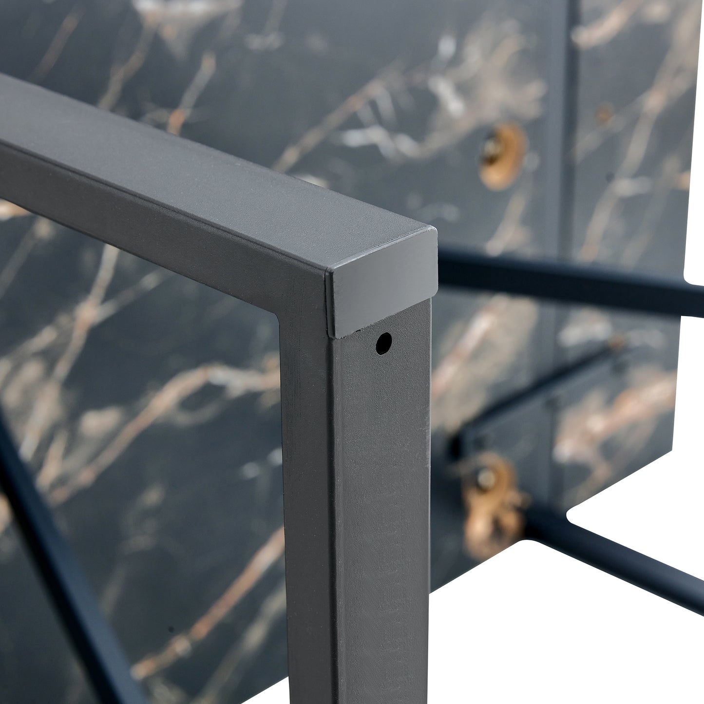 Closeup of dark marble tabletop edge with metal frame