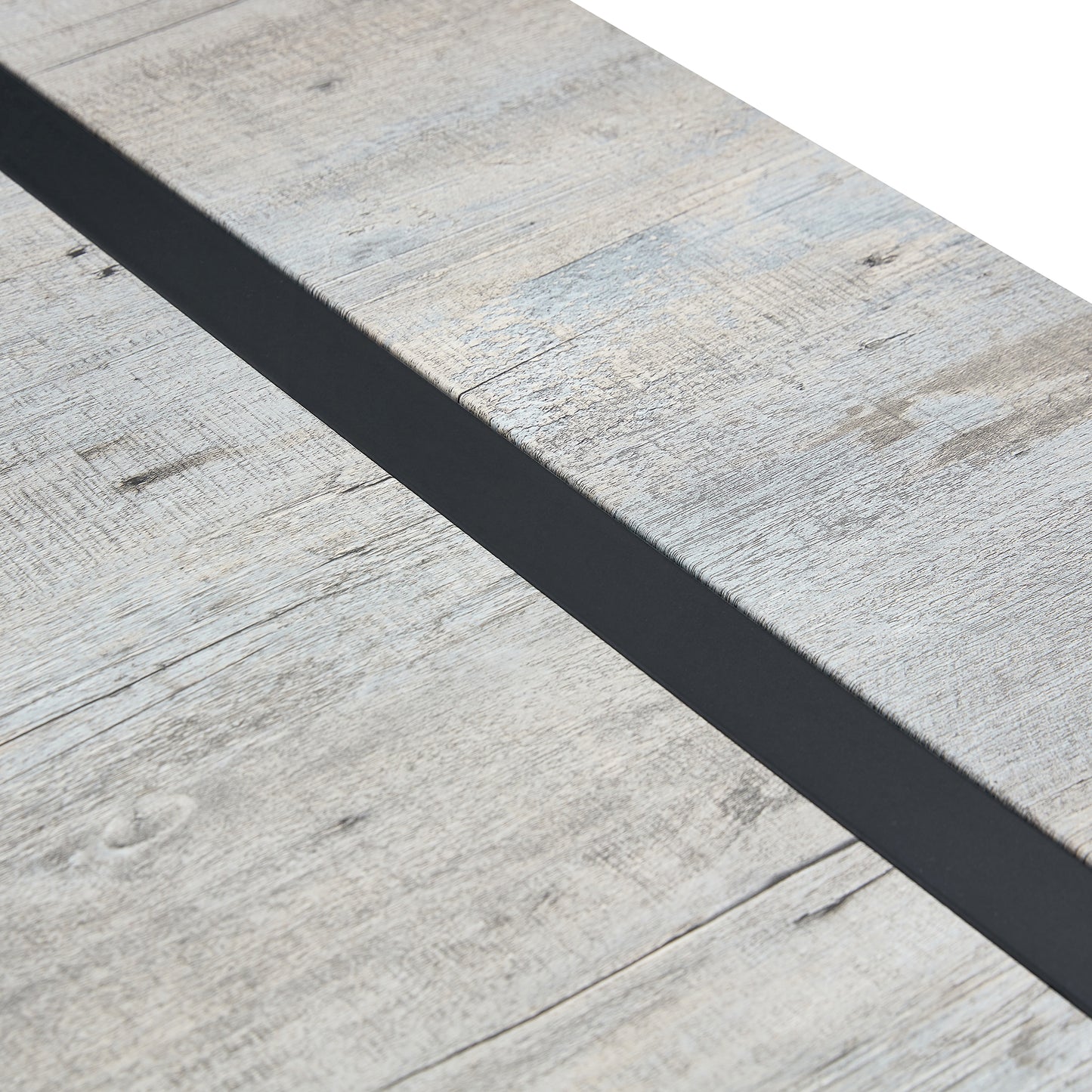 Closeup of a weathered grey wood plank surface with a thin black inlay