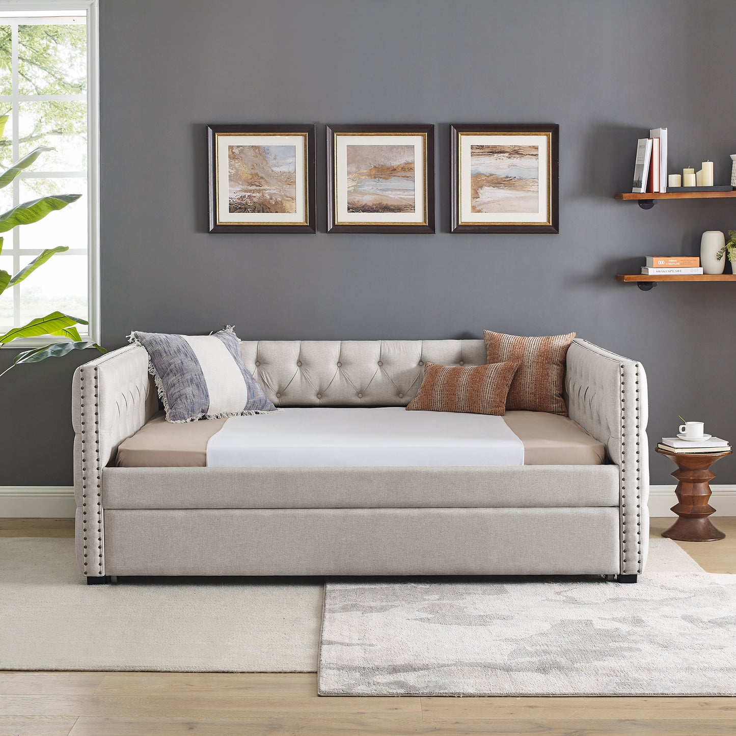 Tufted beige fabric daybed with nailhead trim perfect for small spaces