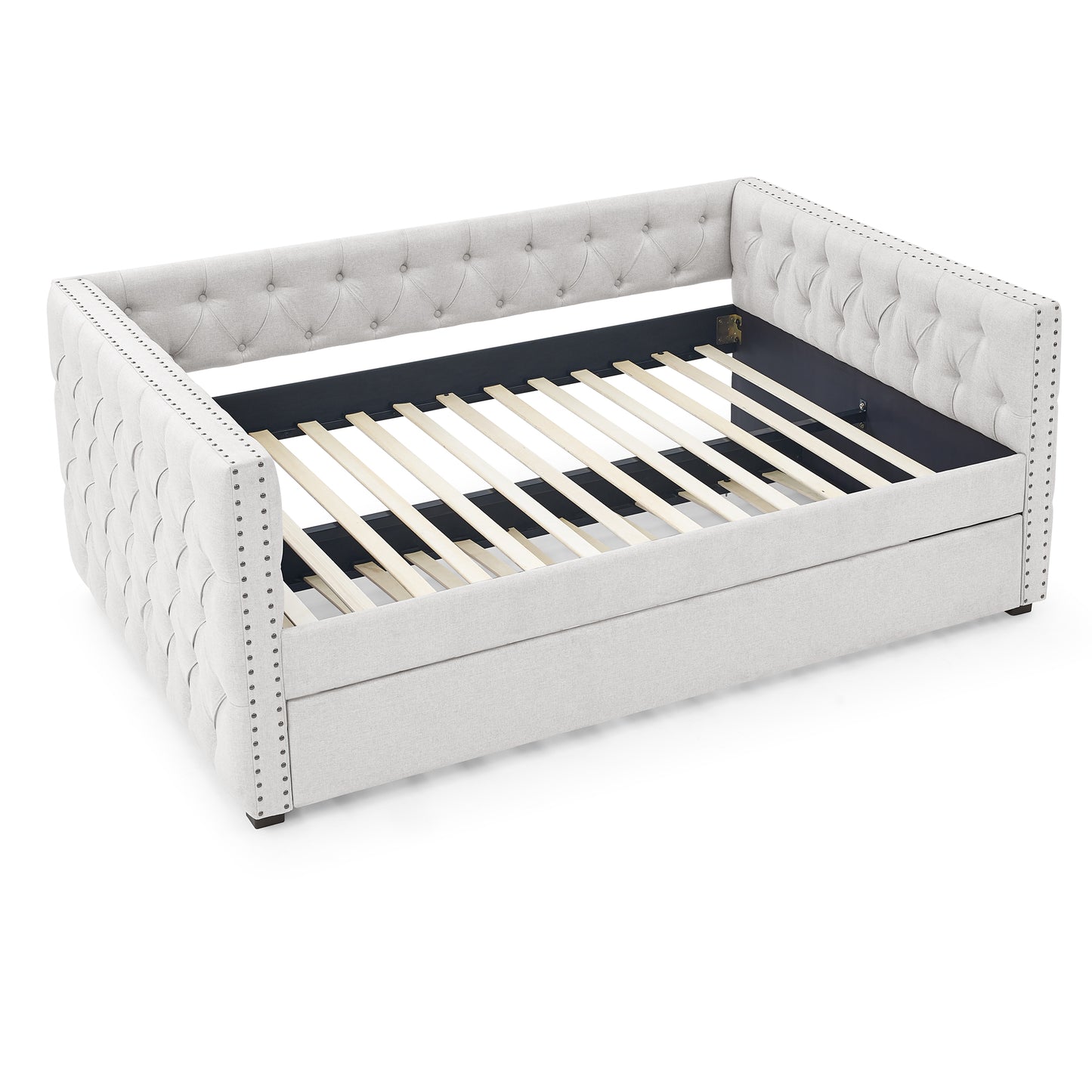 Light grey upholstered daybed with tufted sides and silver nailhead trim ready for mattress