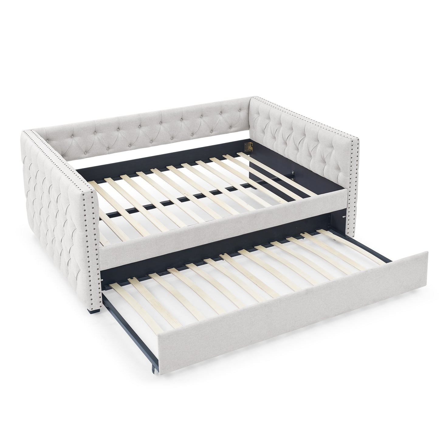 Tufted light gray fabric daybed with pullout trundle and silver nailhead trim