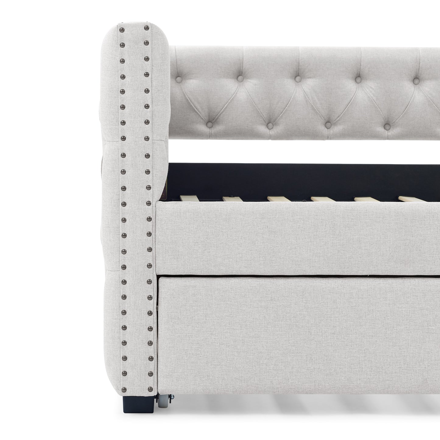 Light grey tufted upholstered bed frame with silver nailhead trim detail