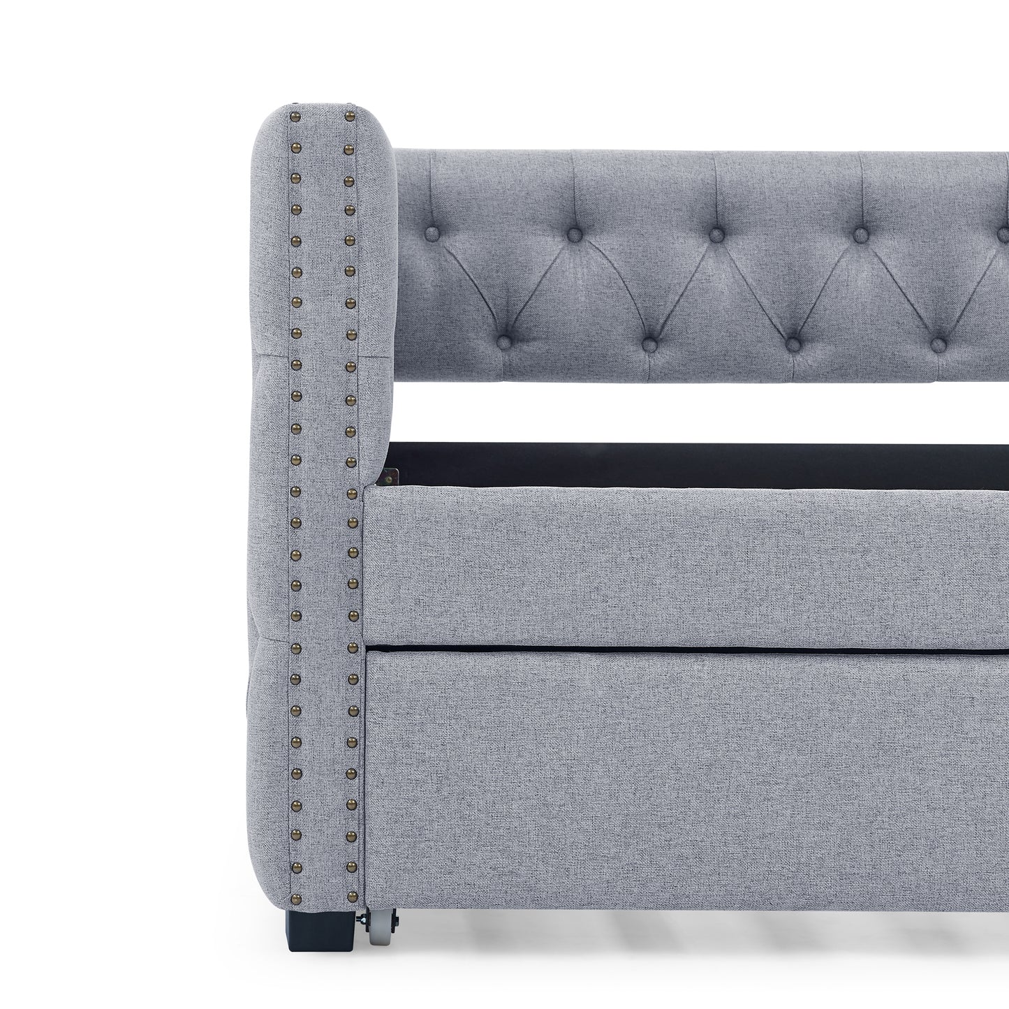 Grey upholstered bed frame with tufted headboard and antique brass nailhead trim