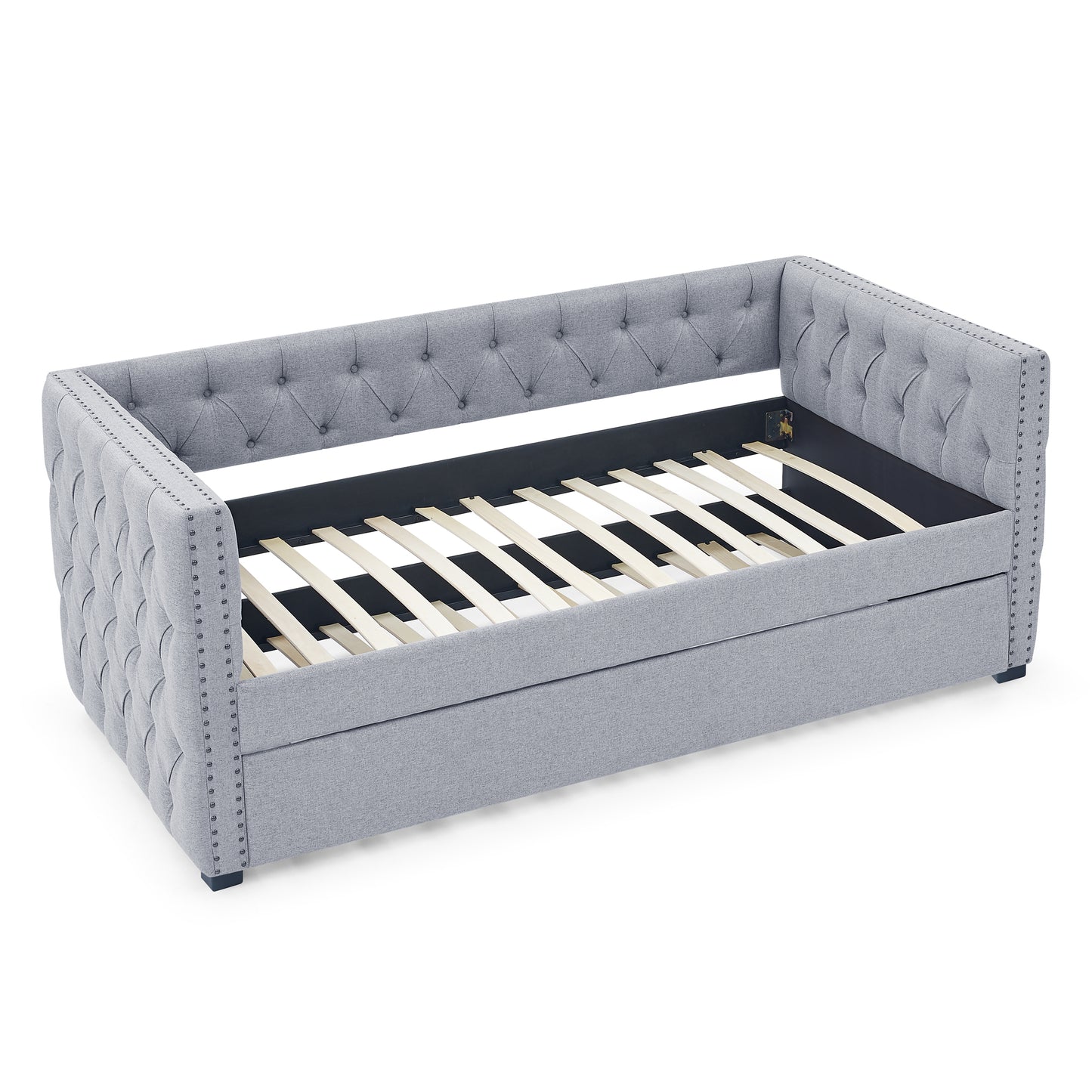 Grey upholstered daybed with tufted back and nailhead trim