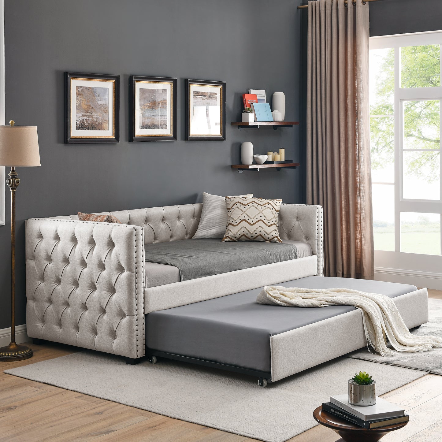 Tufted linen daybed with pullout trundle and nailhead trim