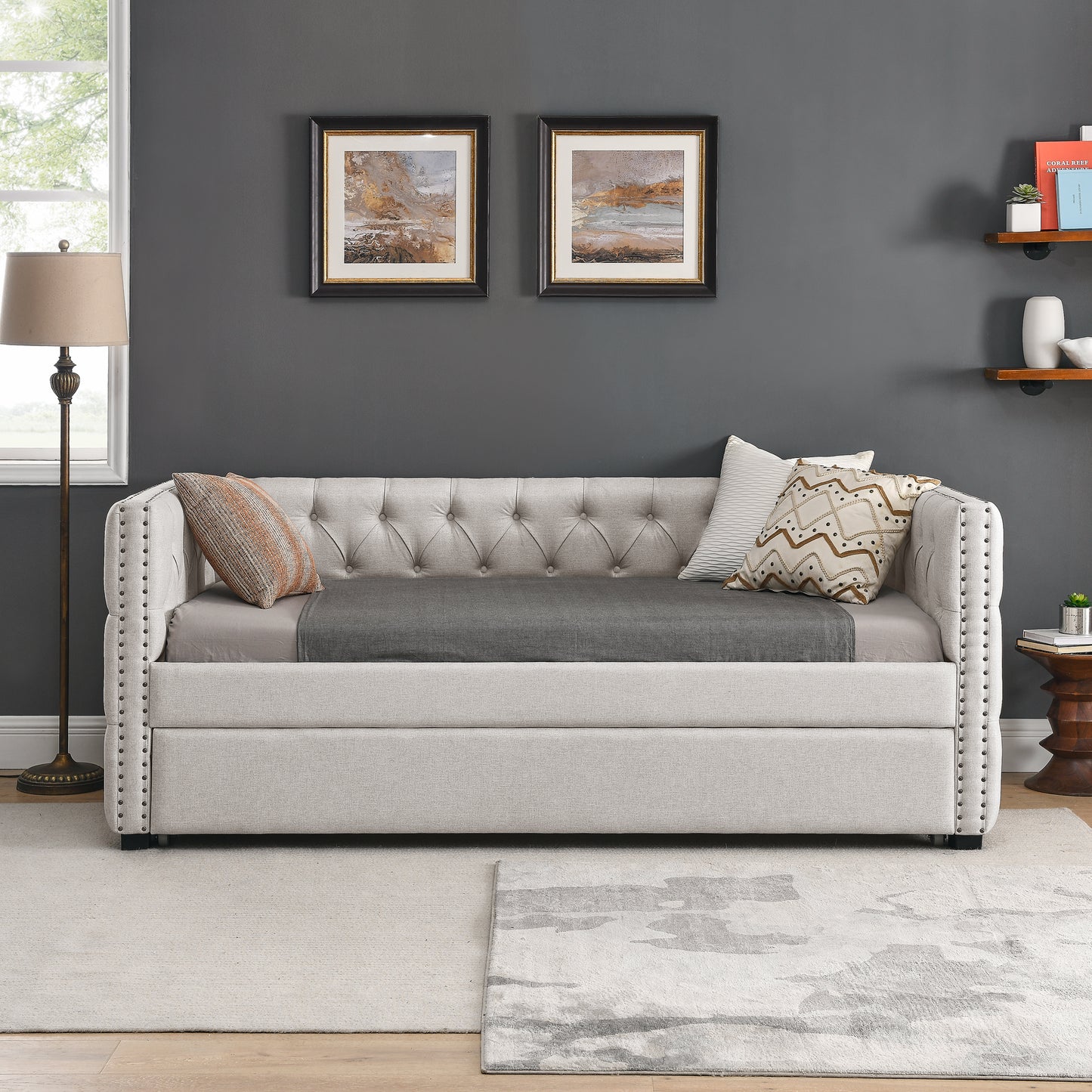 Tufted upholstered daybed in light beige linen with silver nailhead trim