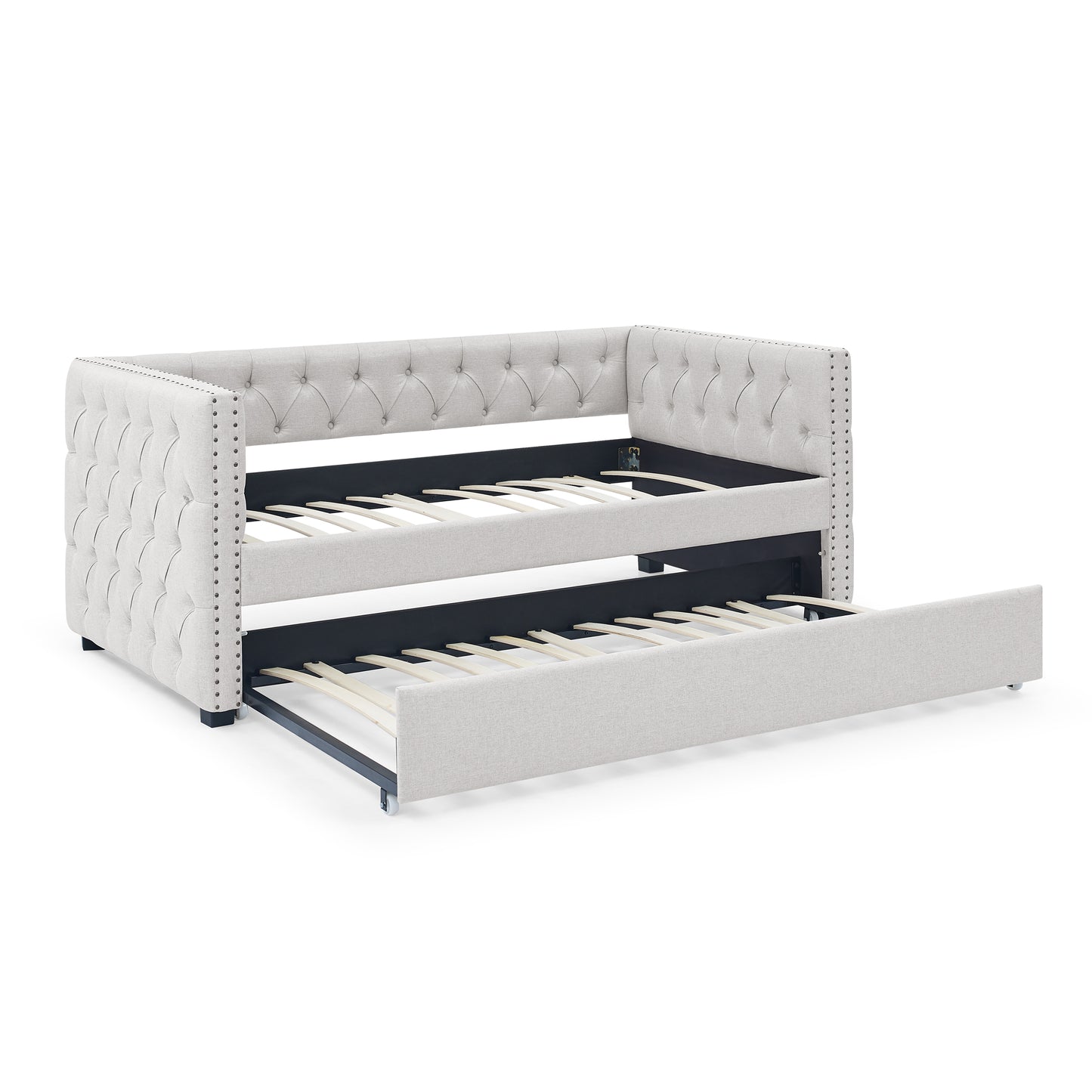 Tufted light gray fabric daybed with pullout trundle and silver nailhead trim