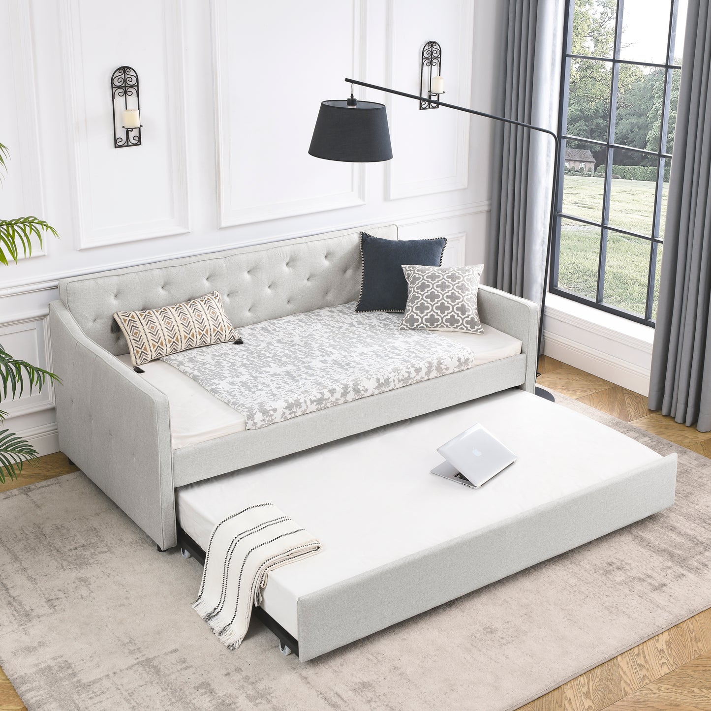 Light gray upholstered daybed with pullout trundle perfect for guest rooms