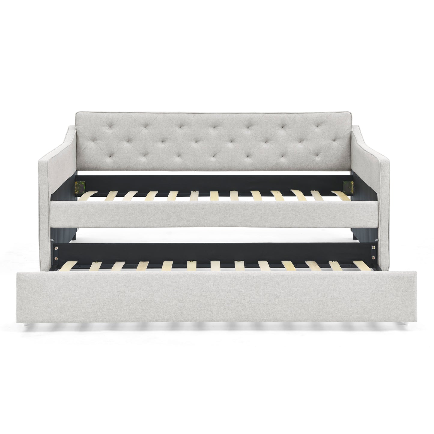 Light grey upholstered daybed with tufted back and pullout trundle bed frame