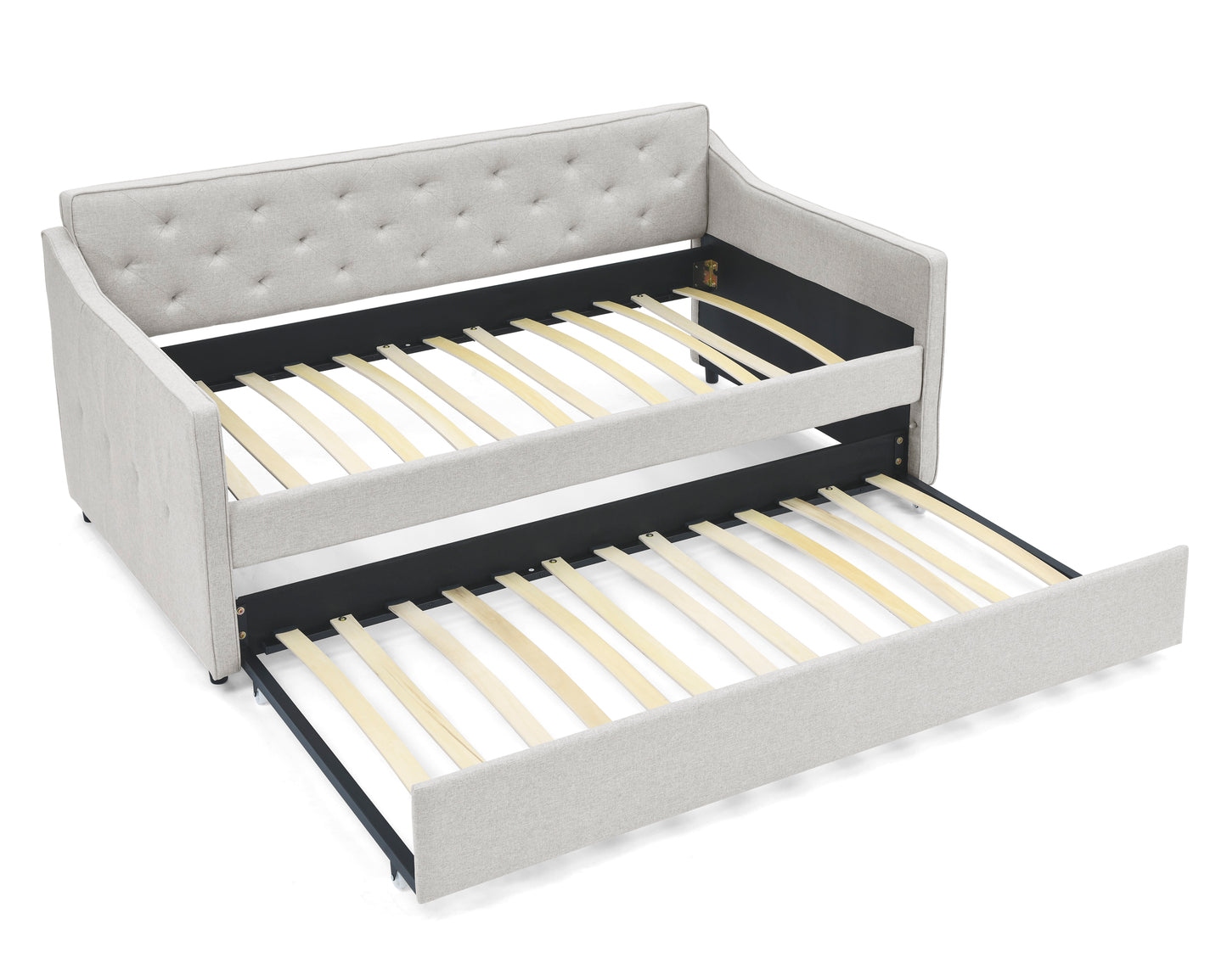 Light grey upholstered daybed with a pullout trundle bed featuring tufted backrest and wooden slats
