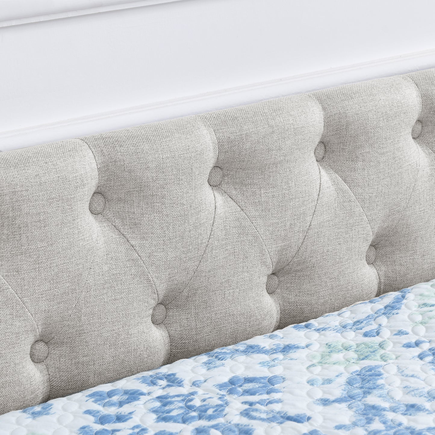 Tufted light gray upholstered headboard with button details part of a modern bed frame set