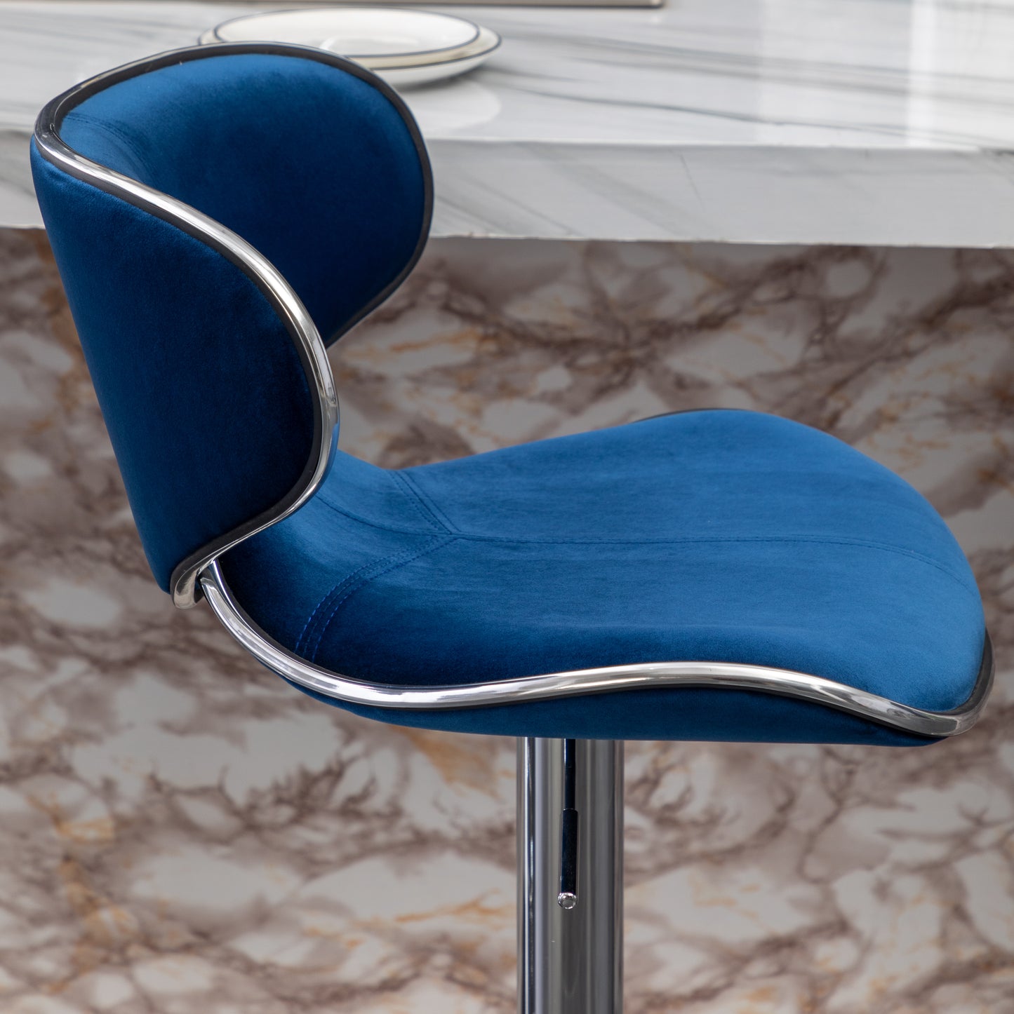 Plush blue velvet bar stool with a sleek chrome trim and adjustable height