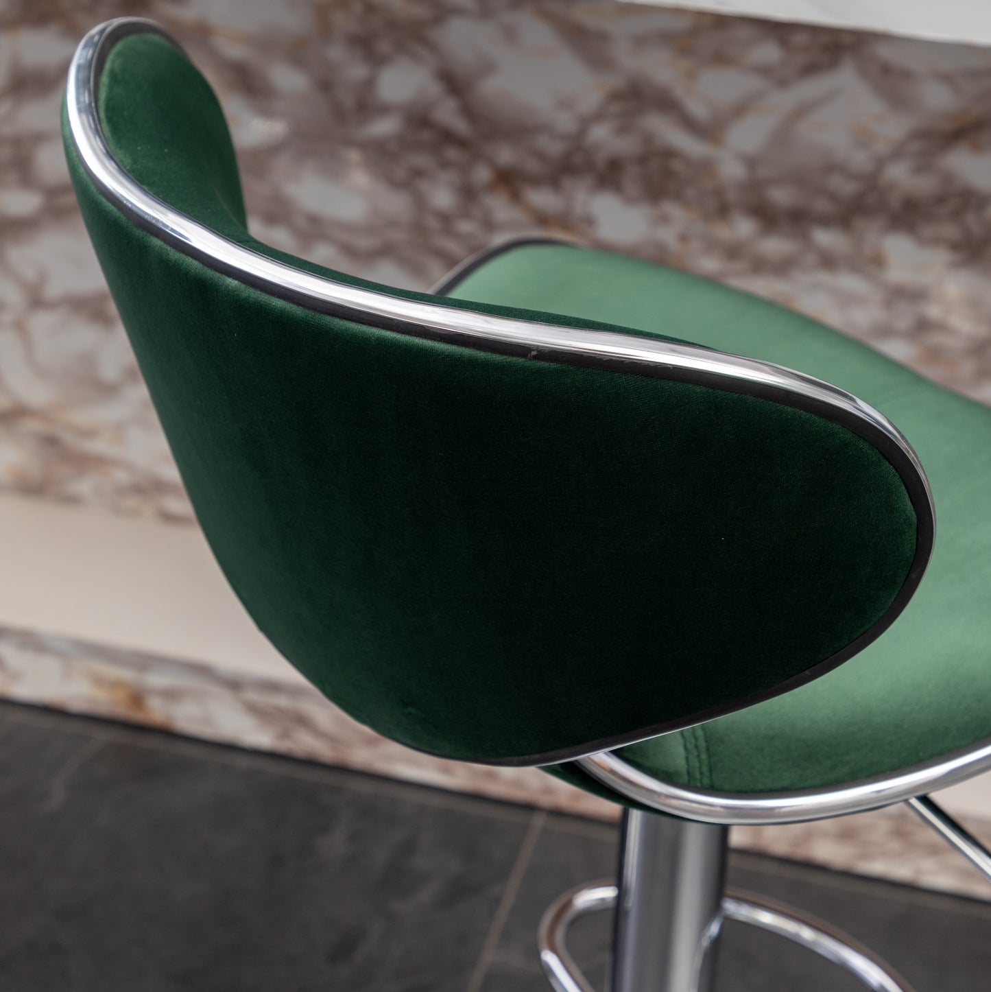 Emerald green velvet bar stool with polished chrome trim