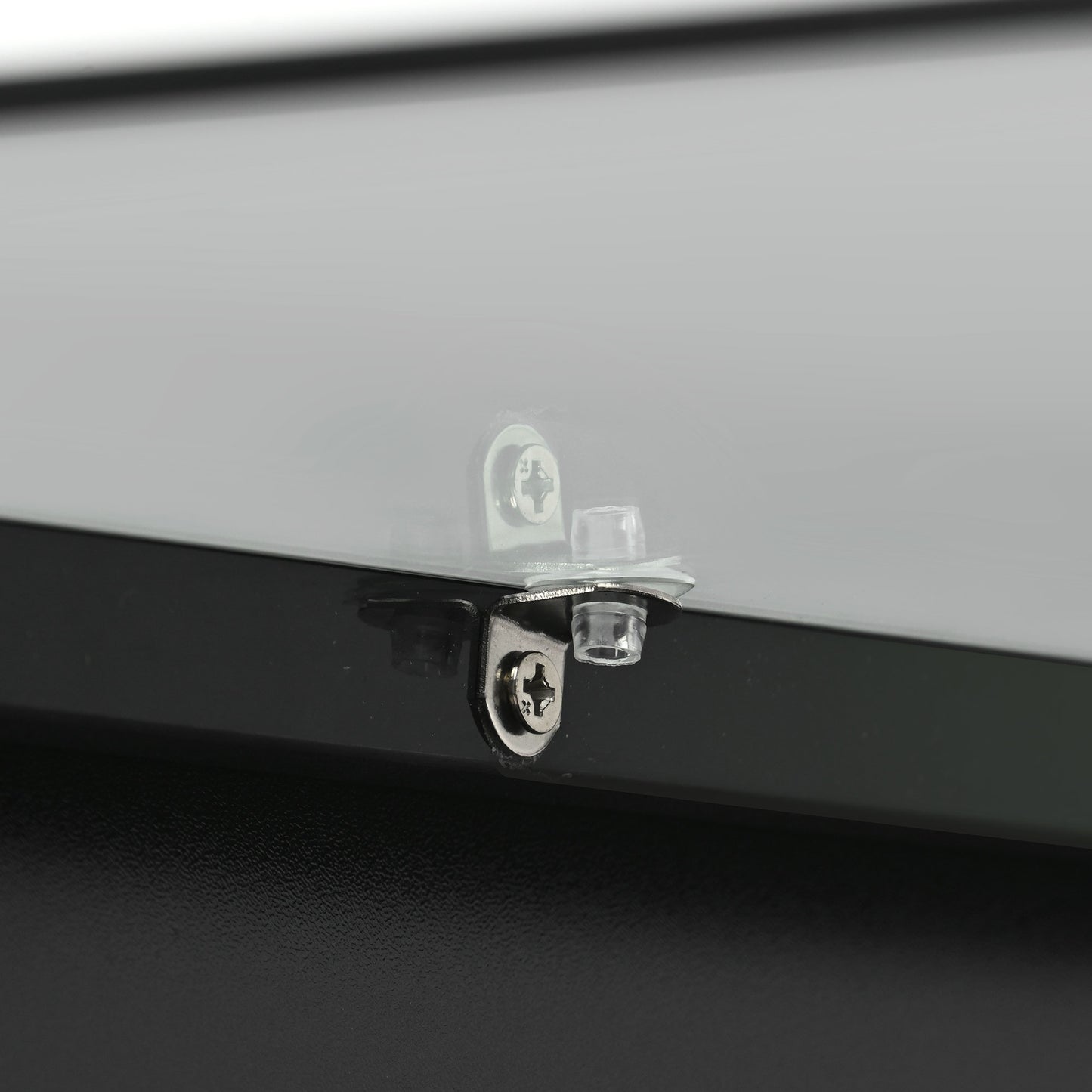Closeup of glass shelf support with chrome screw and clear plastic bushing