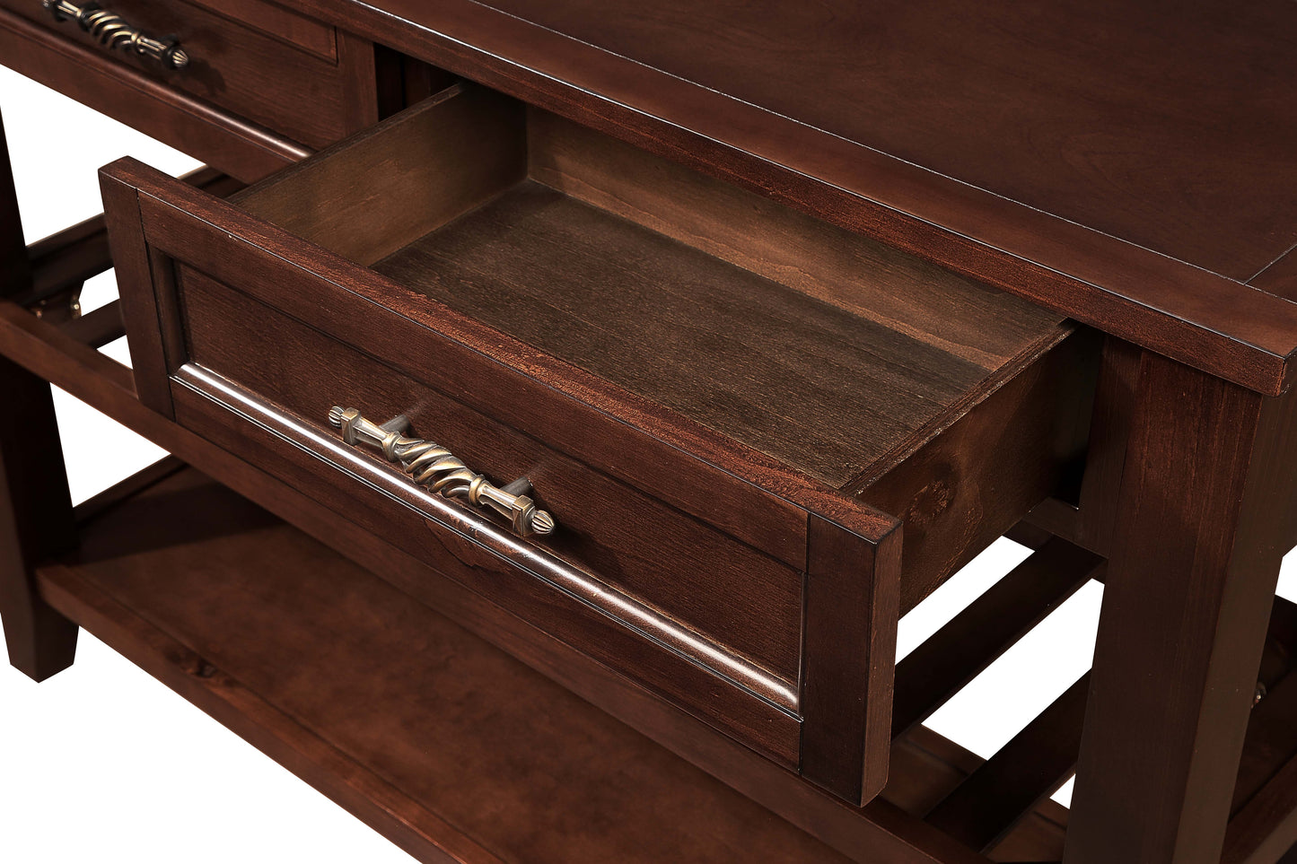 Ornate brass handle on open dark wood drawer of a console table