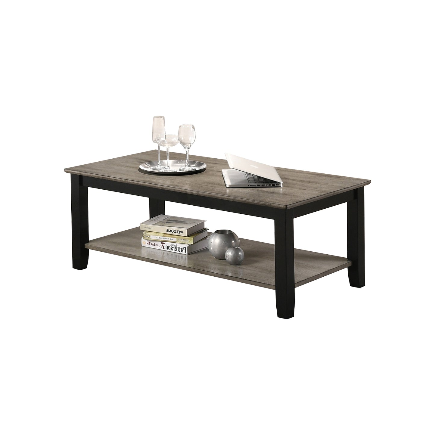 Rustic gray wood coffee table with black frame and lower shelf holding books and decor