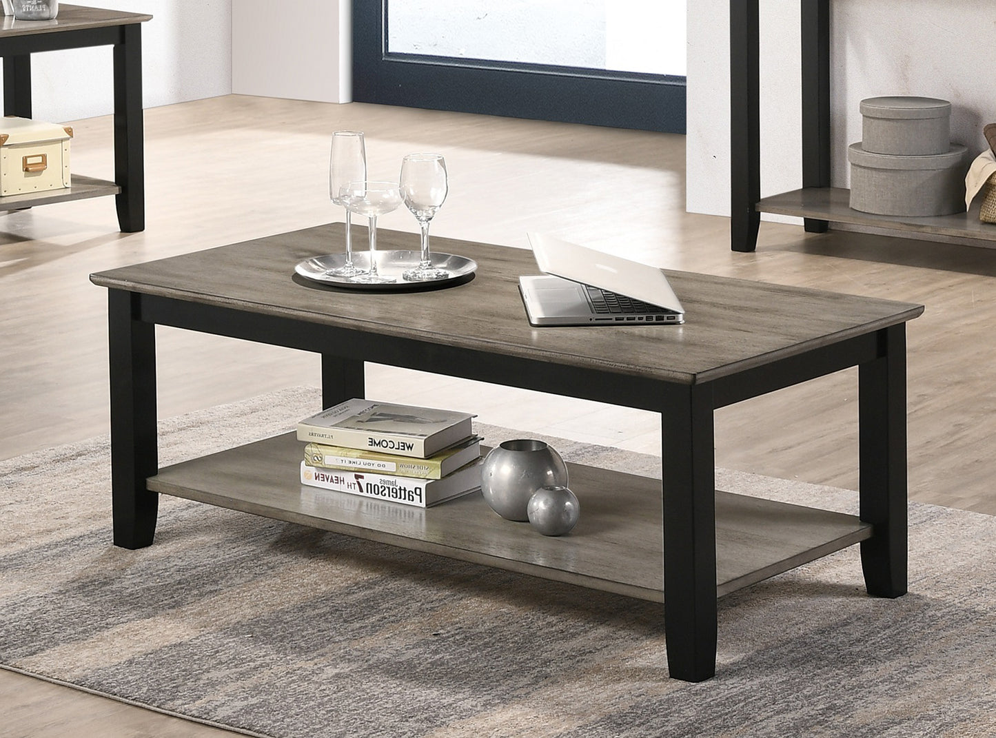Modern rectangular coffee table with gray wood top and black frame includes lower shelf