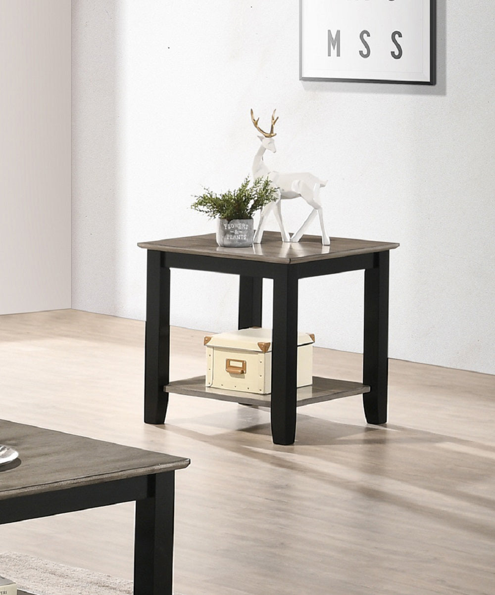 Square end table with weathered gray top and black frame holding decorative box