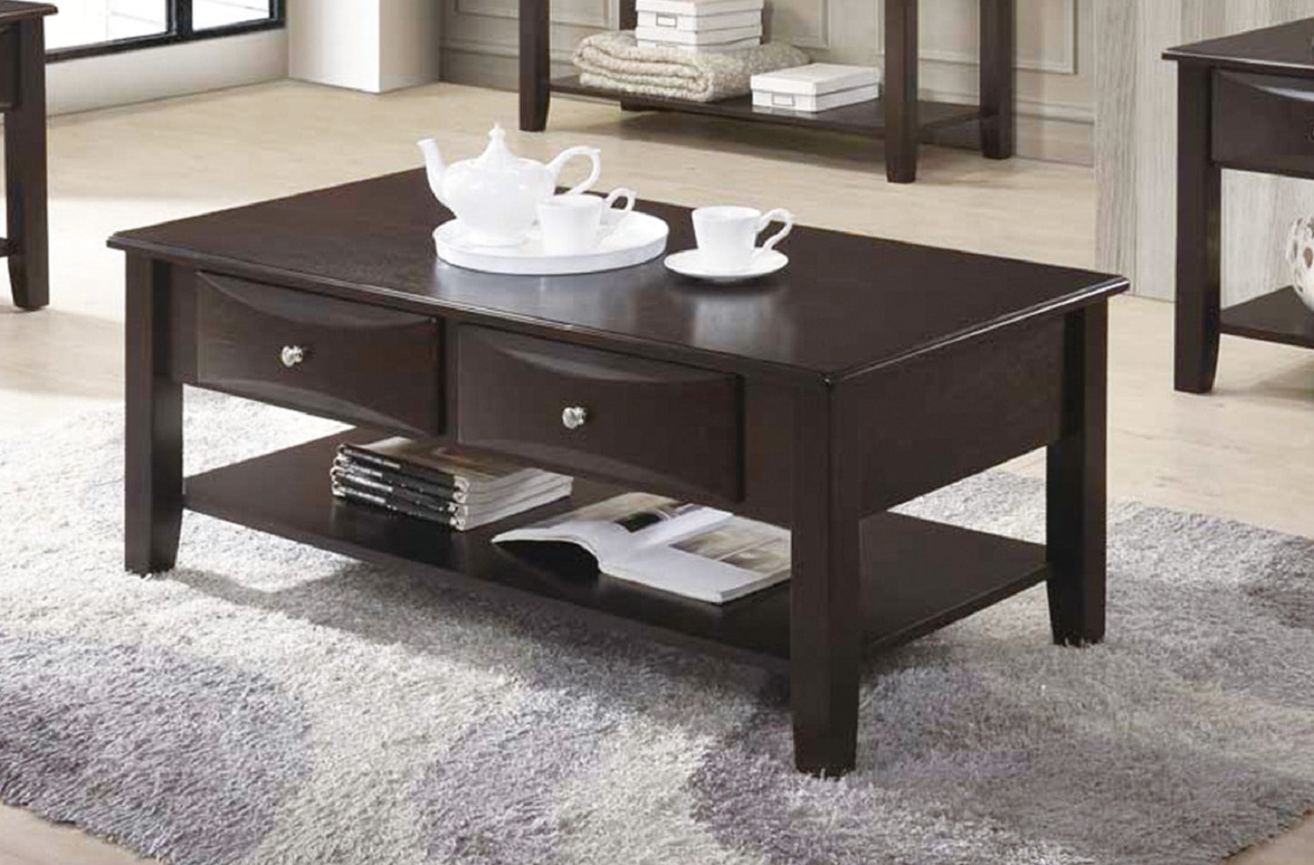 Dark brown wooden coffee table with two drawers and a lower shelf featuring a teapot and cups