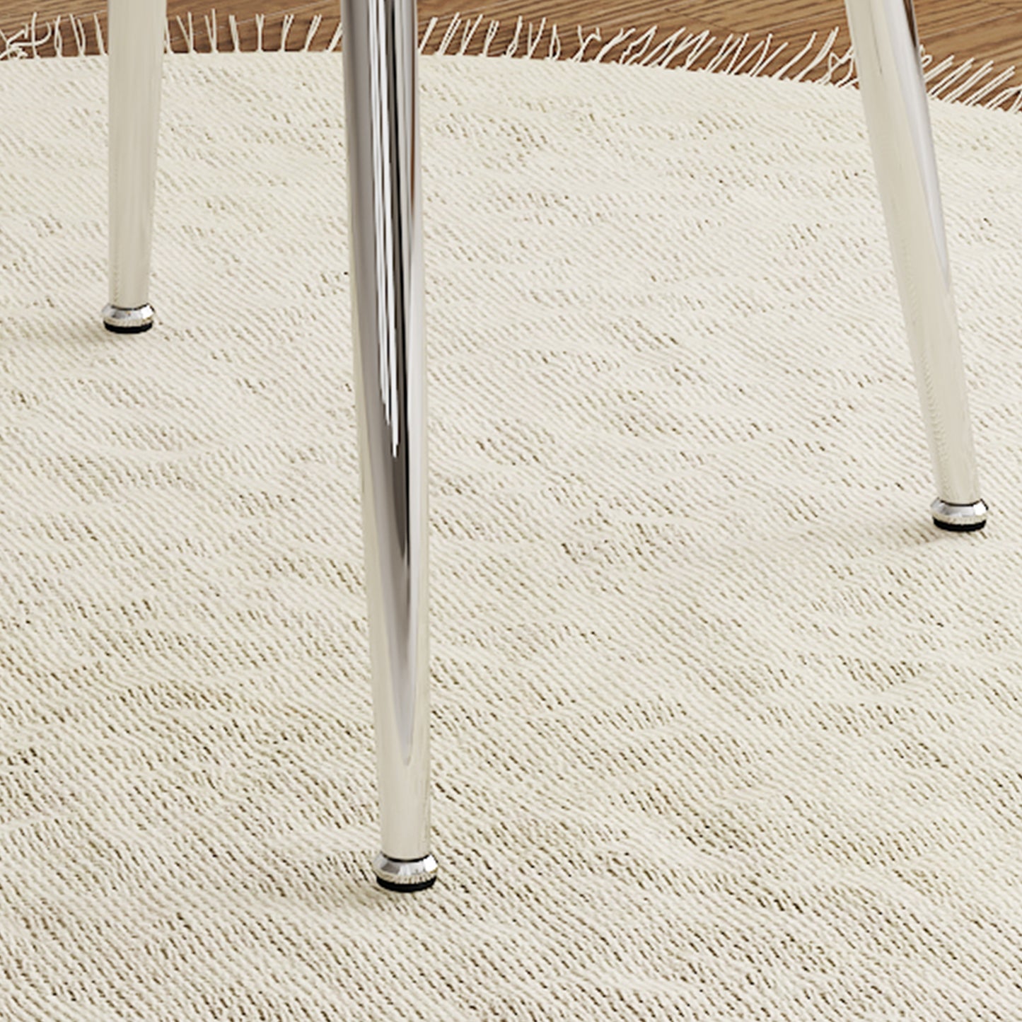 Chrome dining chair legs on a textured cream rug
