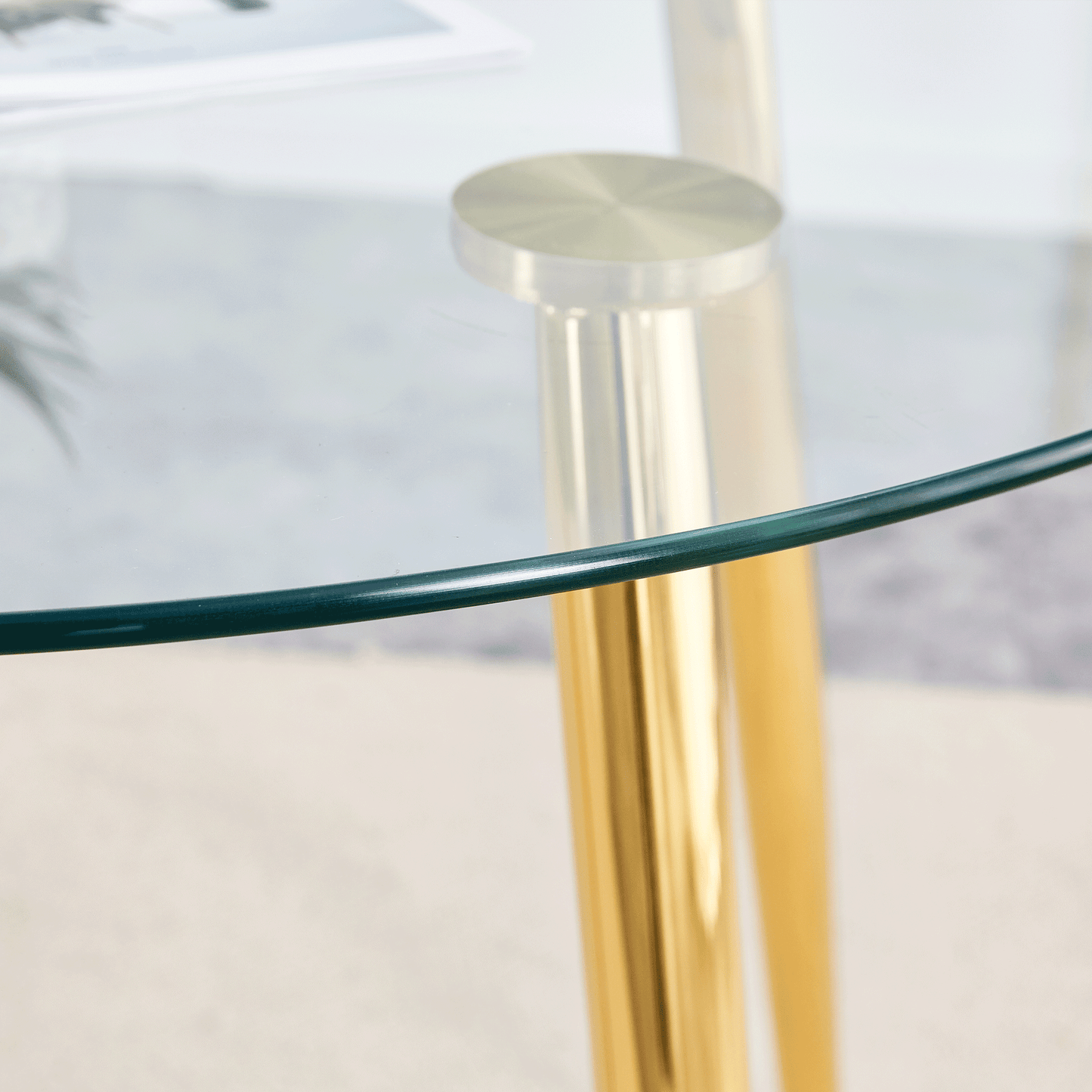 Elegant round glass coffee table with polished brass legs