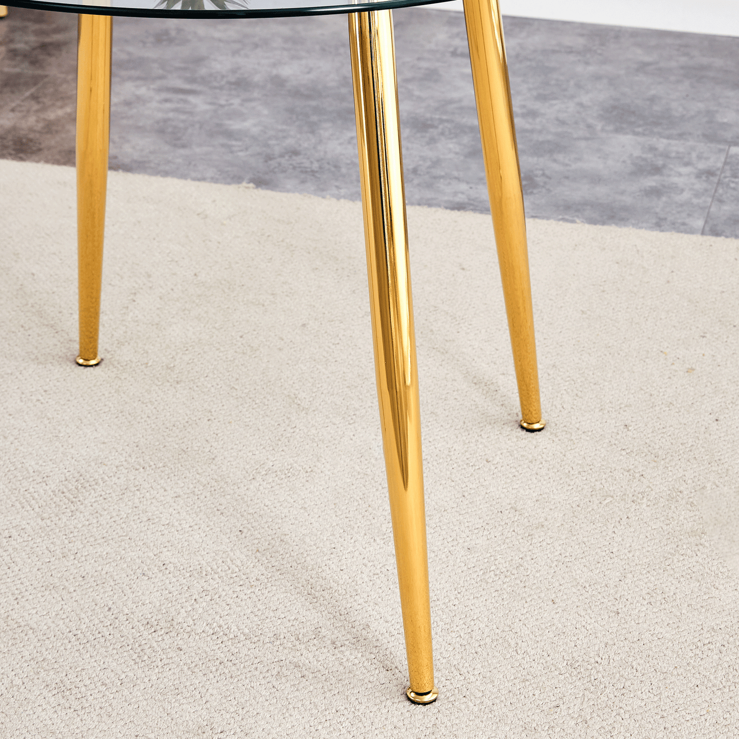 Elegant gold metal legs on a round glasstop table