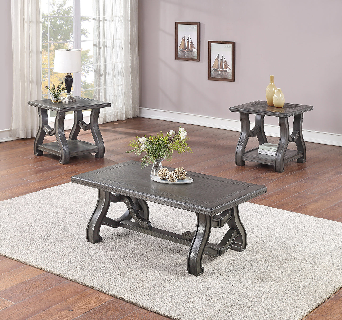 Dark gray carved wood coffee table with ornate legs on a textured rug