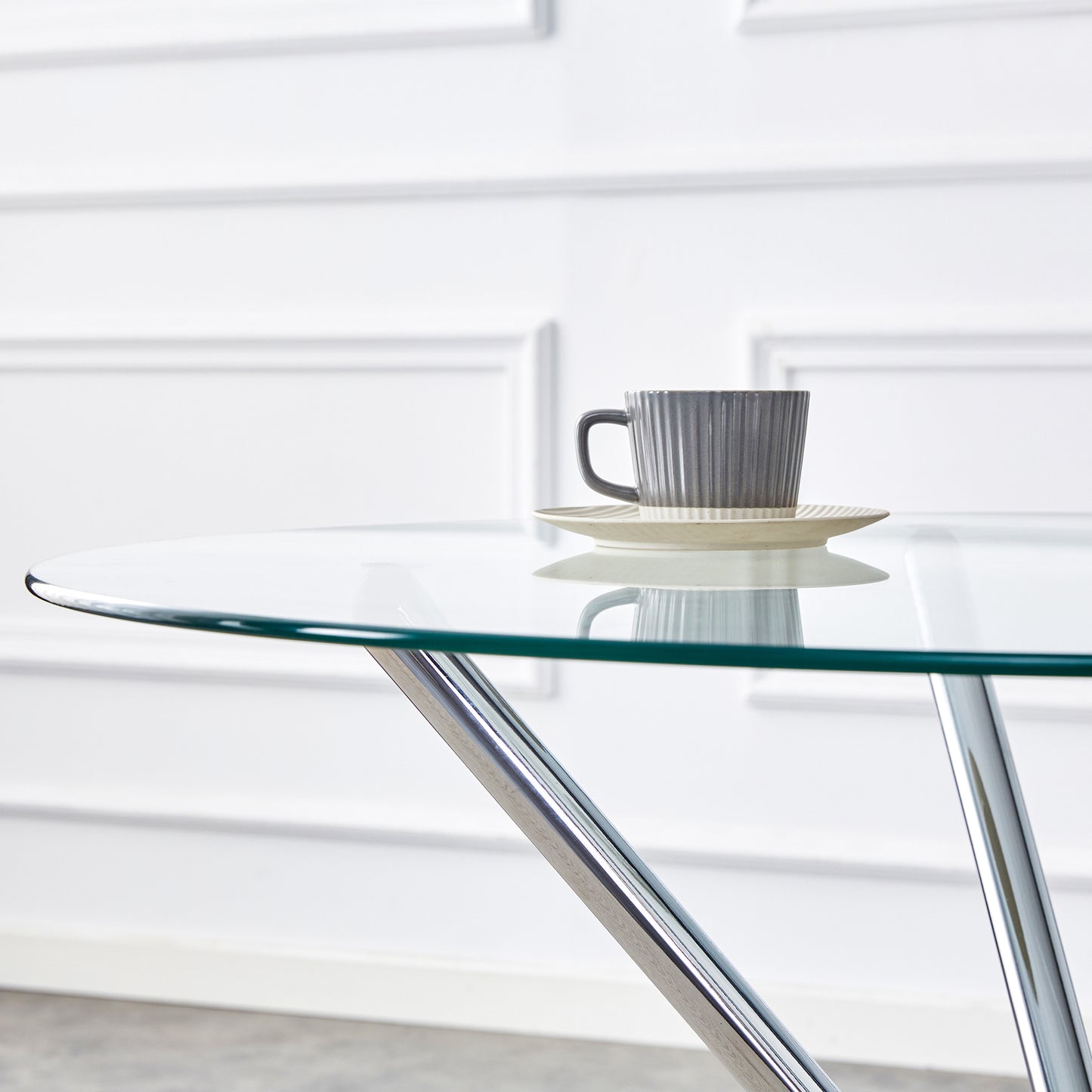 Round glass dining table with polished chrome legs