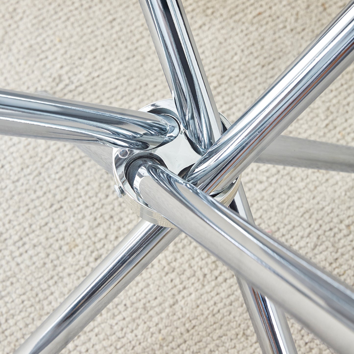 Closeup of a polished chrome fivestar base for a swivel chair