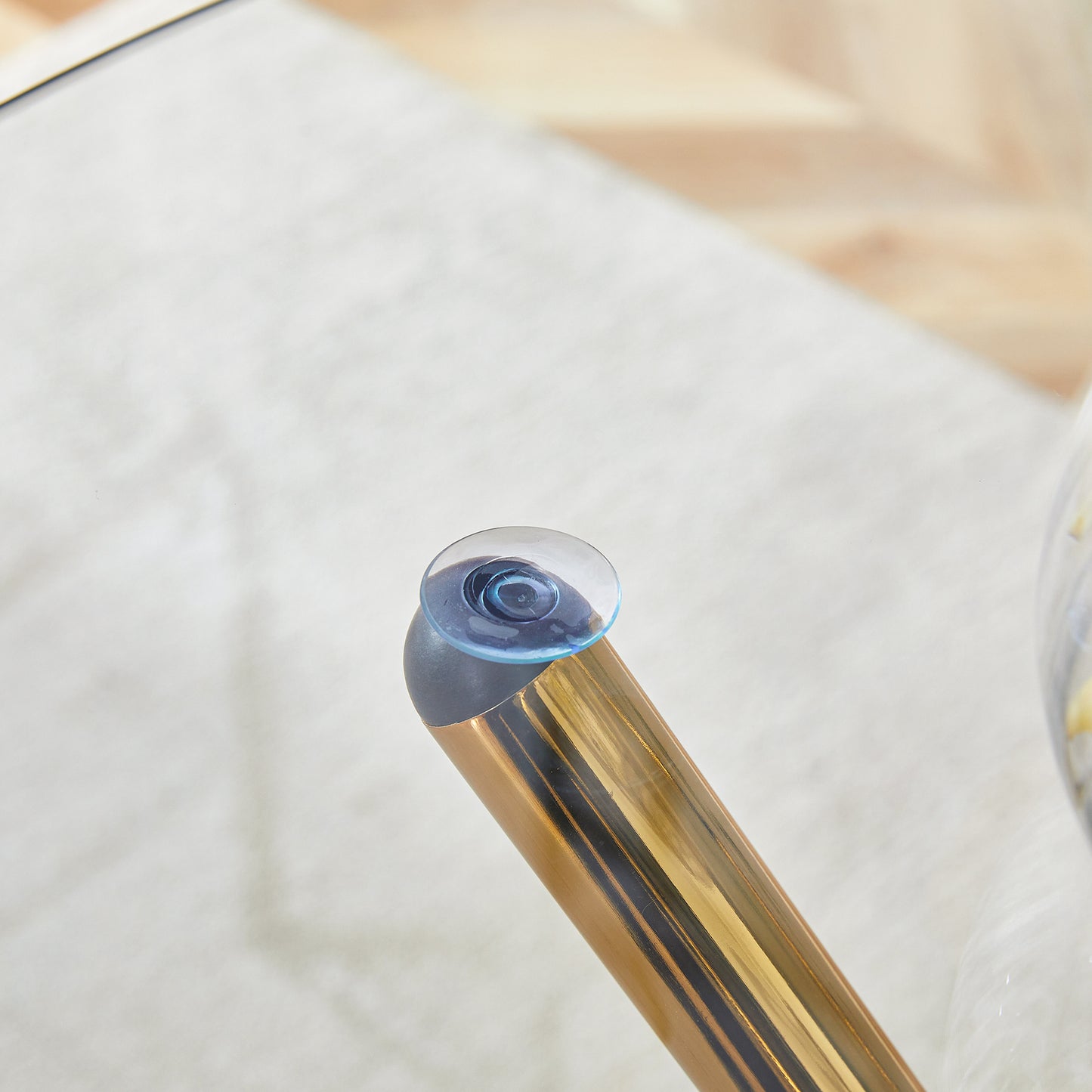 Blue tinted soft contact lens on a gold table leg