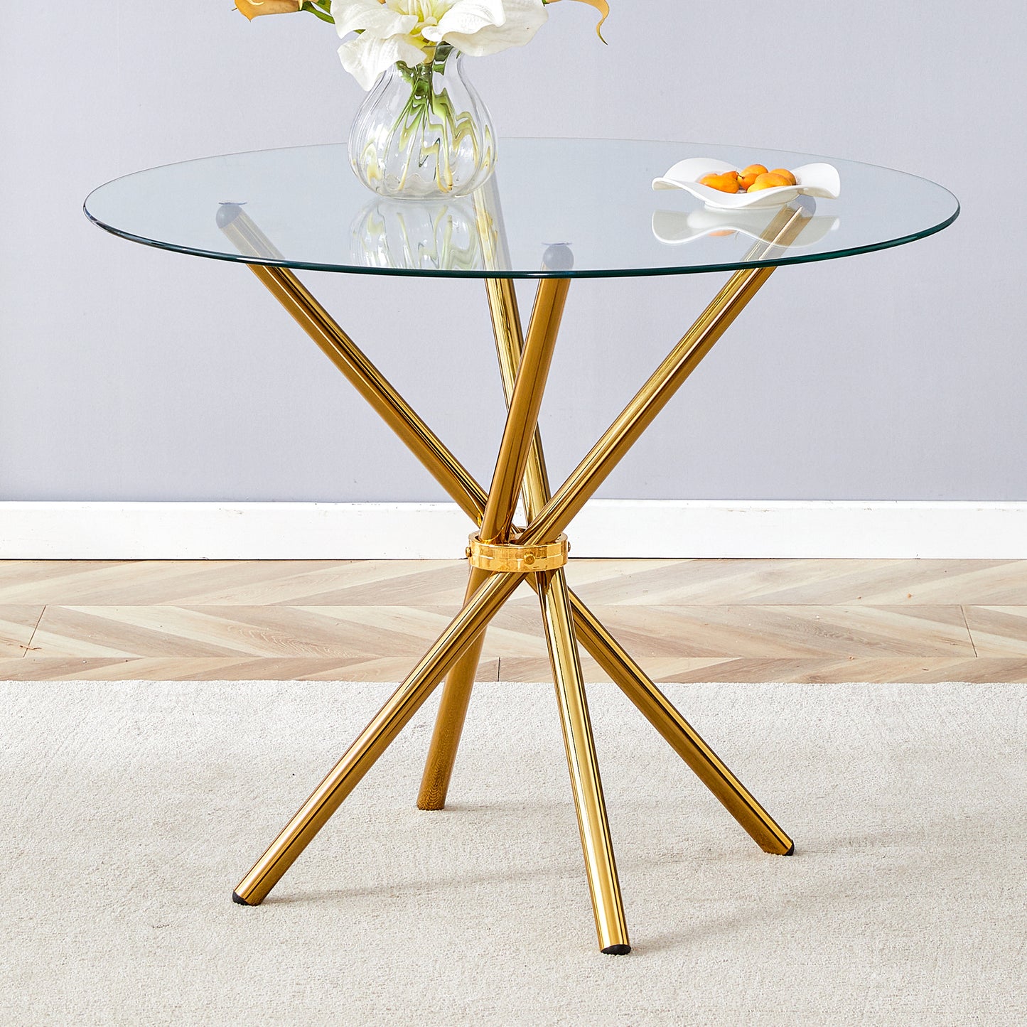 Round glass top dining table with gold pedestal base