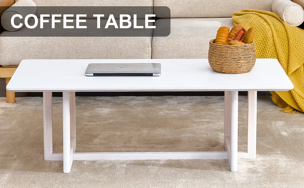 Minimalist white rectangular coffee table with a laptop