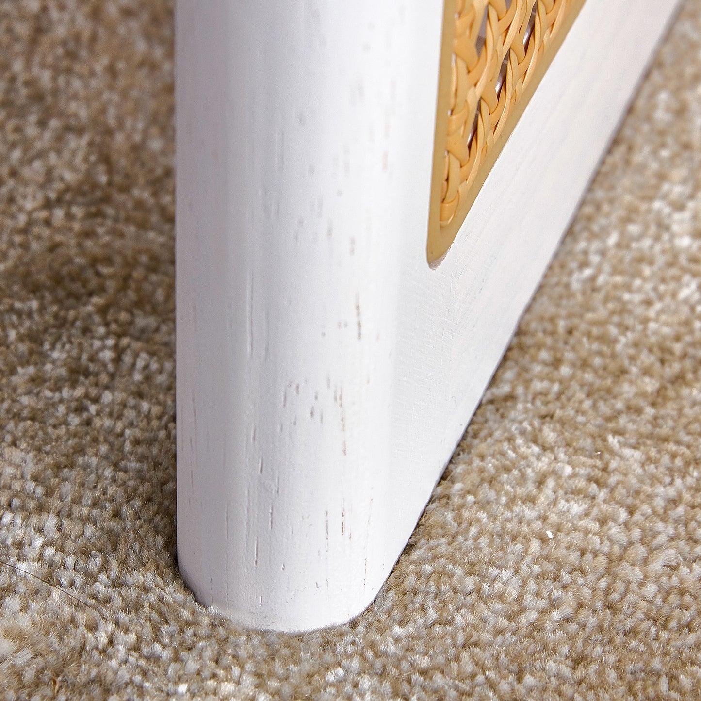 White wooden furniture leg with woven rattan accent