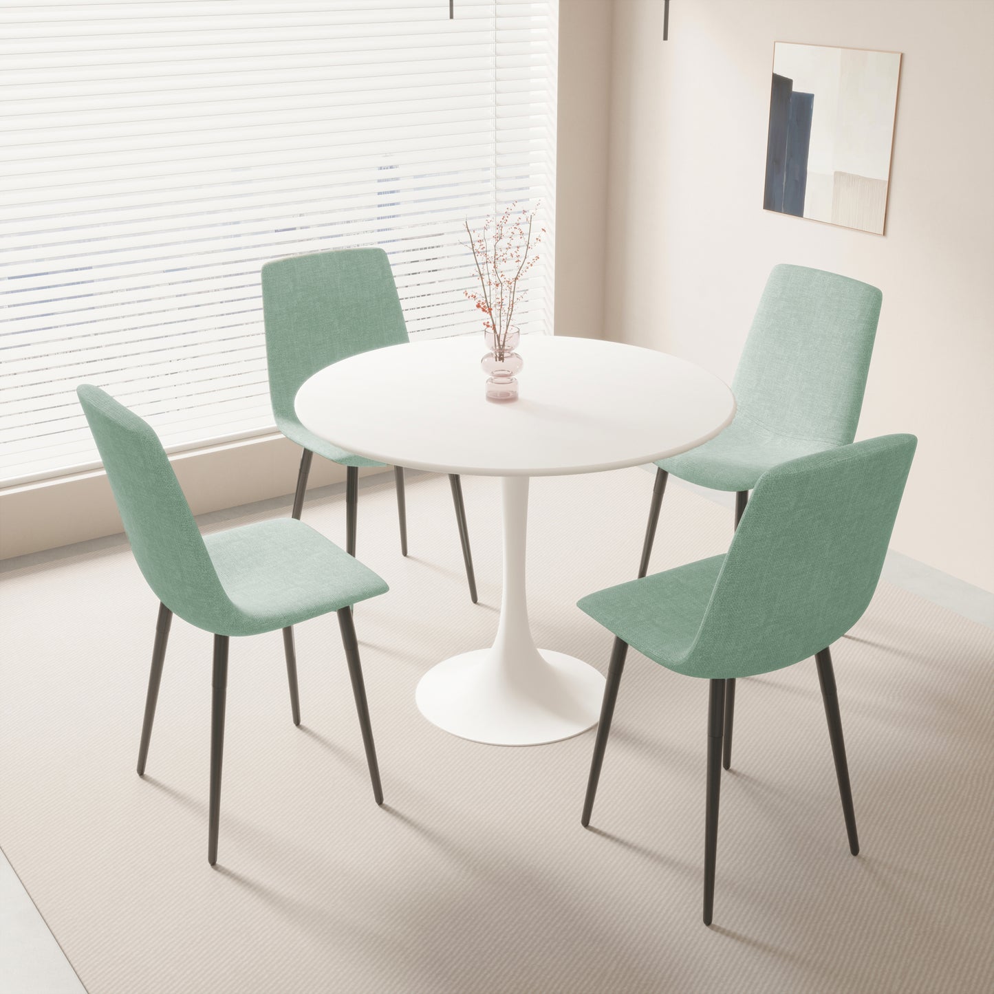 Modern round white dining table with four upholstered teal chairs