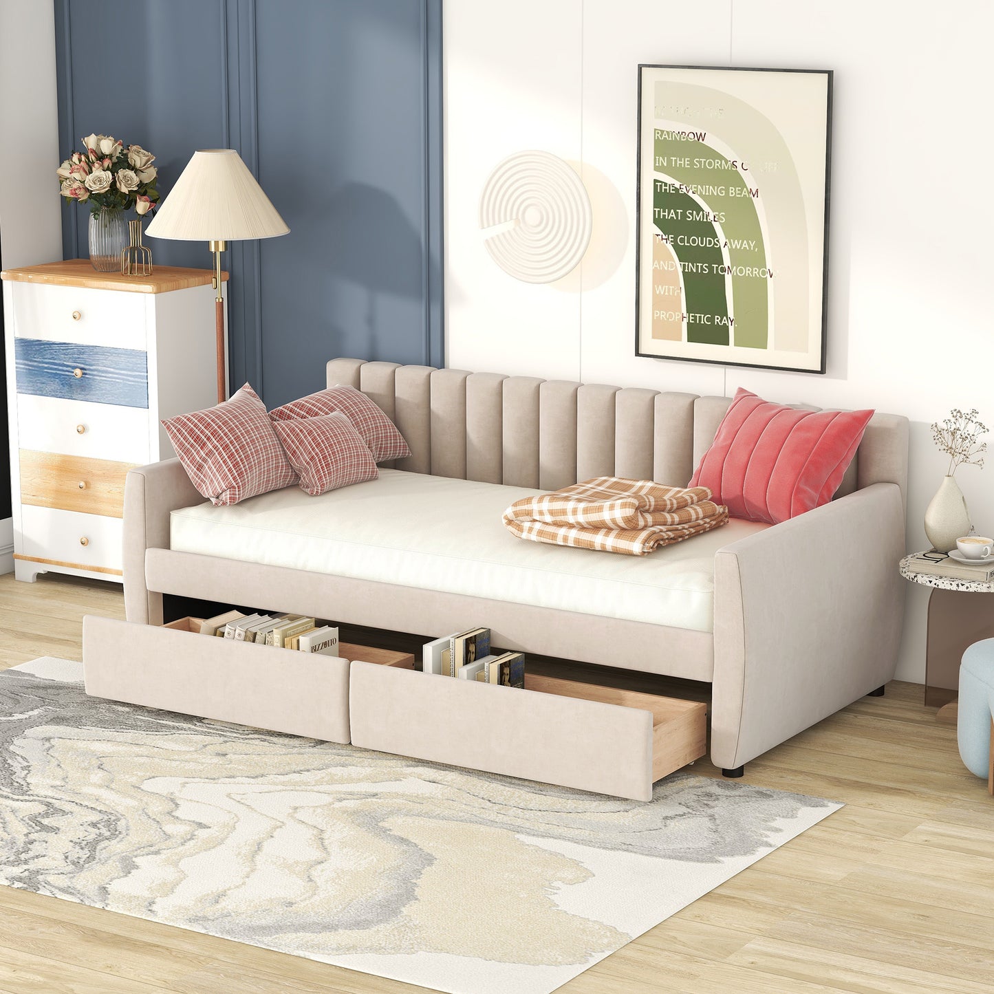Beige upholstered sofa bed with storage drawers and plaid pillows