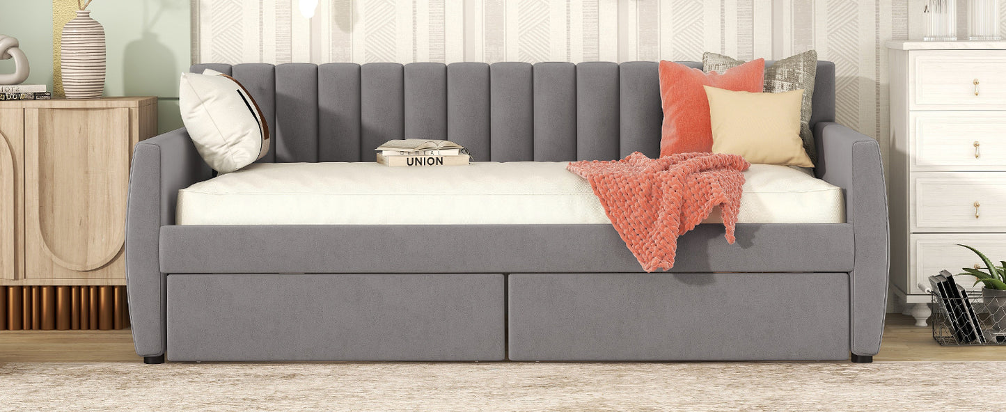 Grey velvet daybed with vertical channel tufting and two storage drawers
