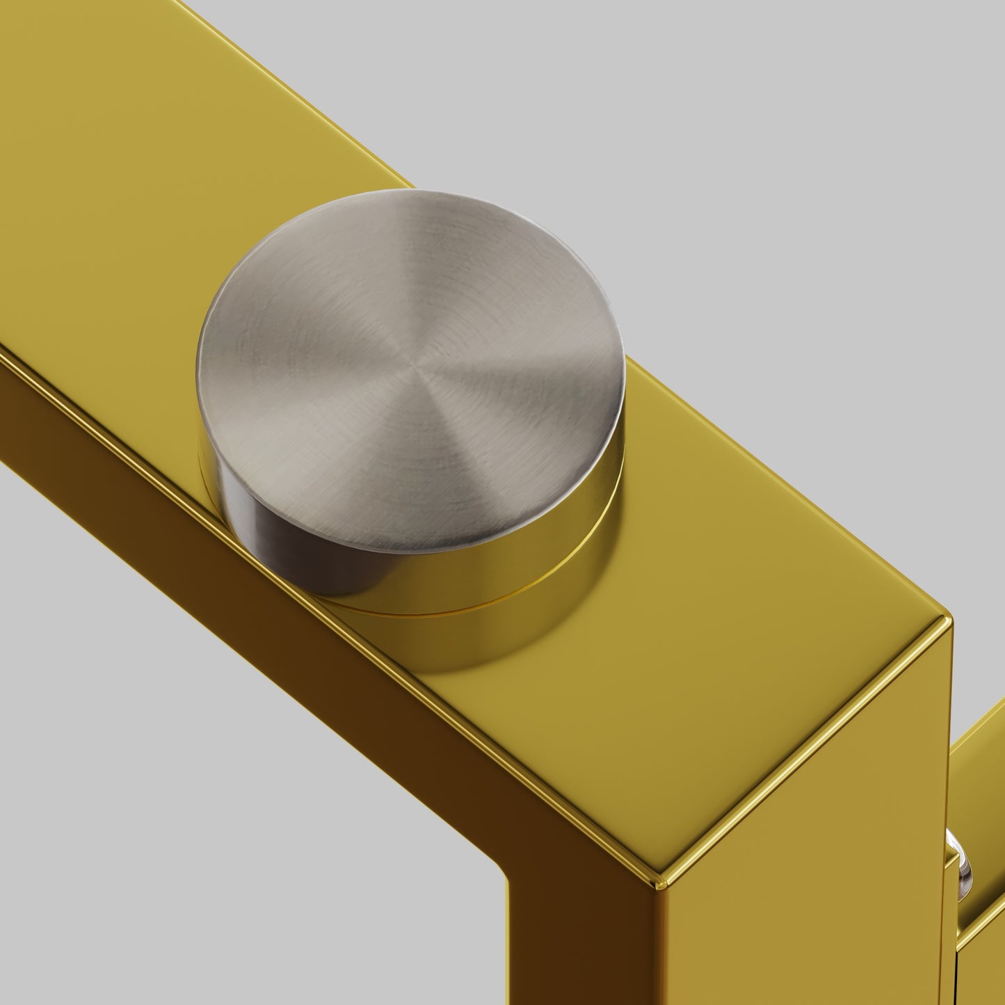 Brushed nickel knob on a polished brass cabinet handle
