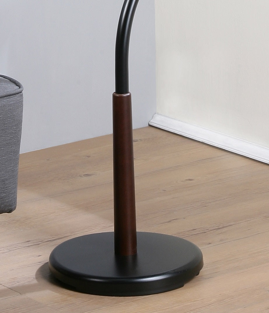 Black metal base and wooden pole of an adjustable floor lamp