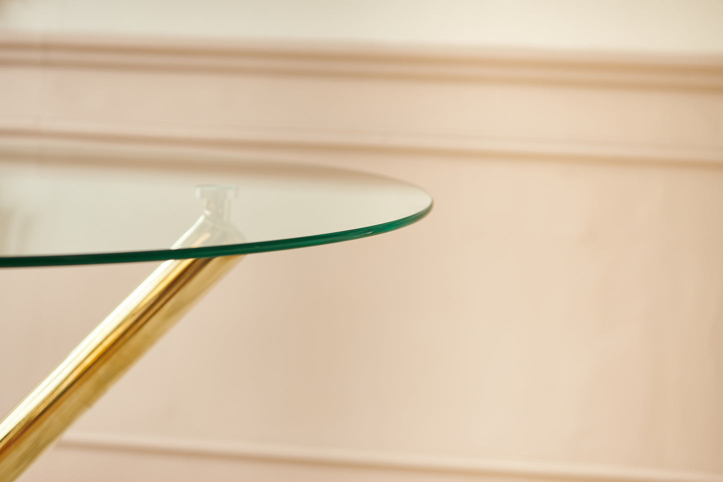 Round tempered glass tabletop with polished gold pedestal base