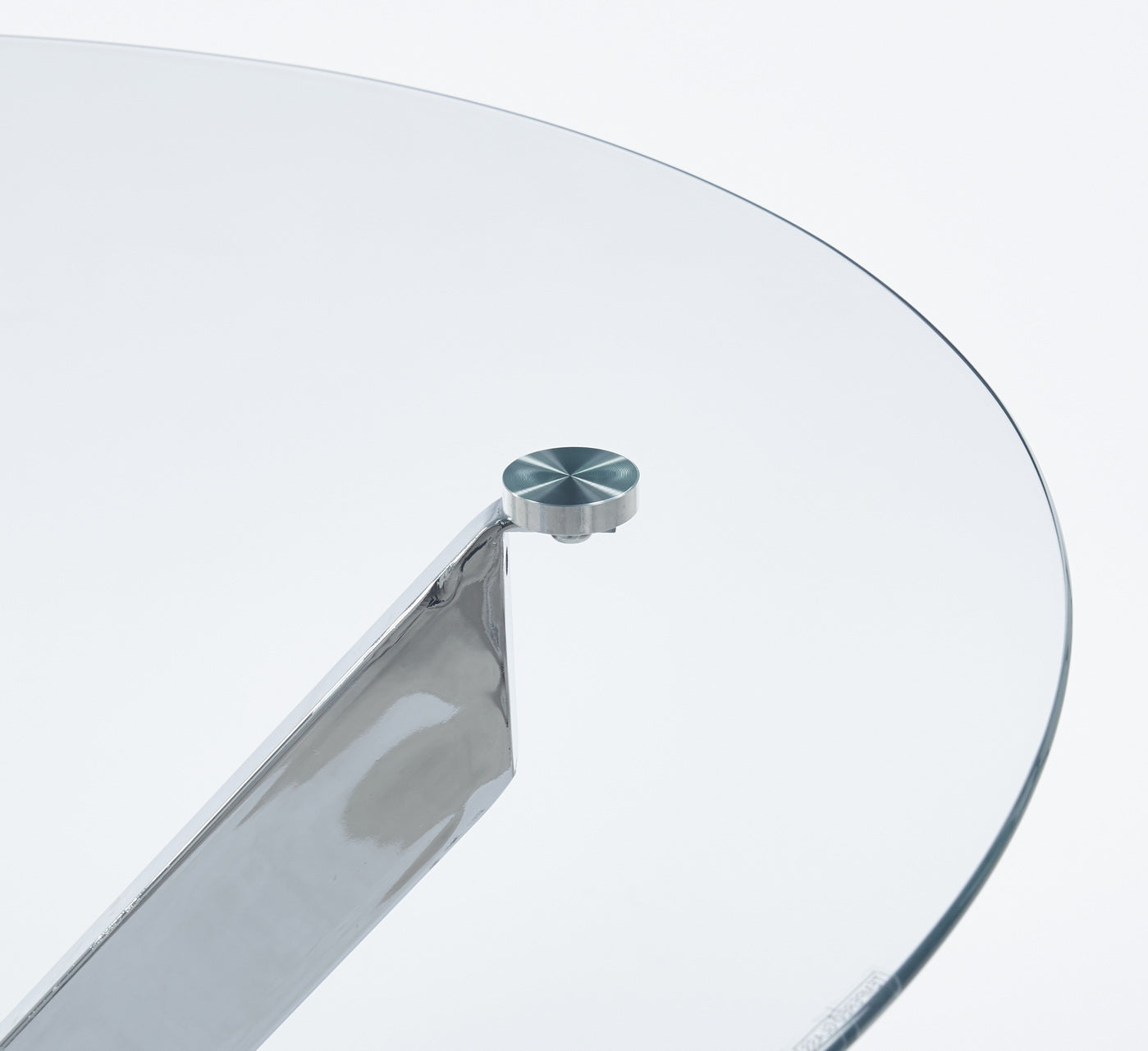 Polished chrome leg detail on a round glass coffee table