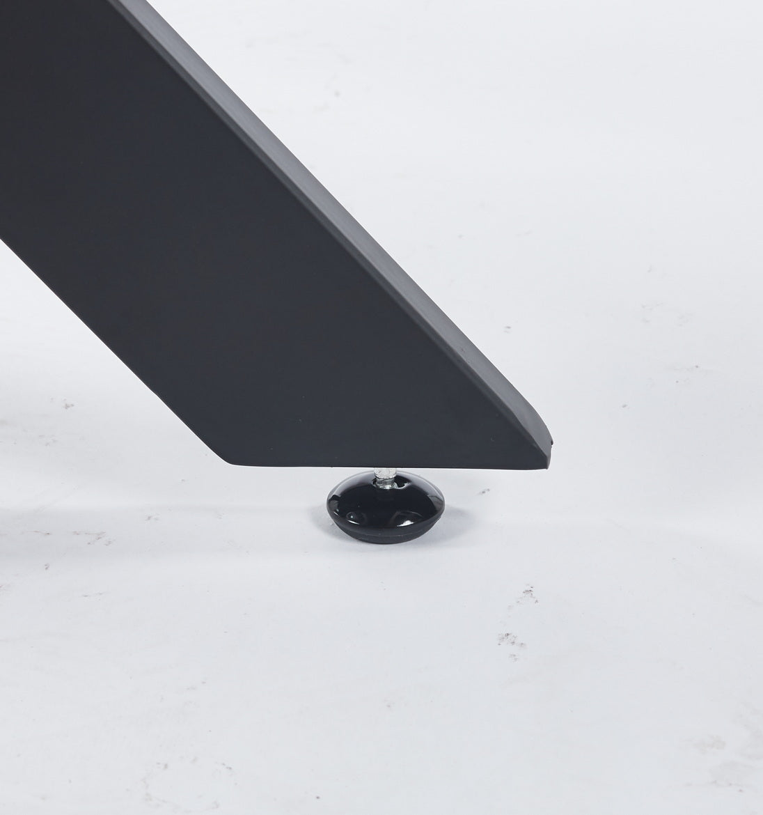 Black metal table leg with adjustable foot on white background
