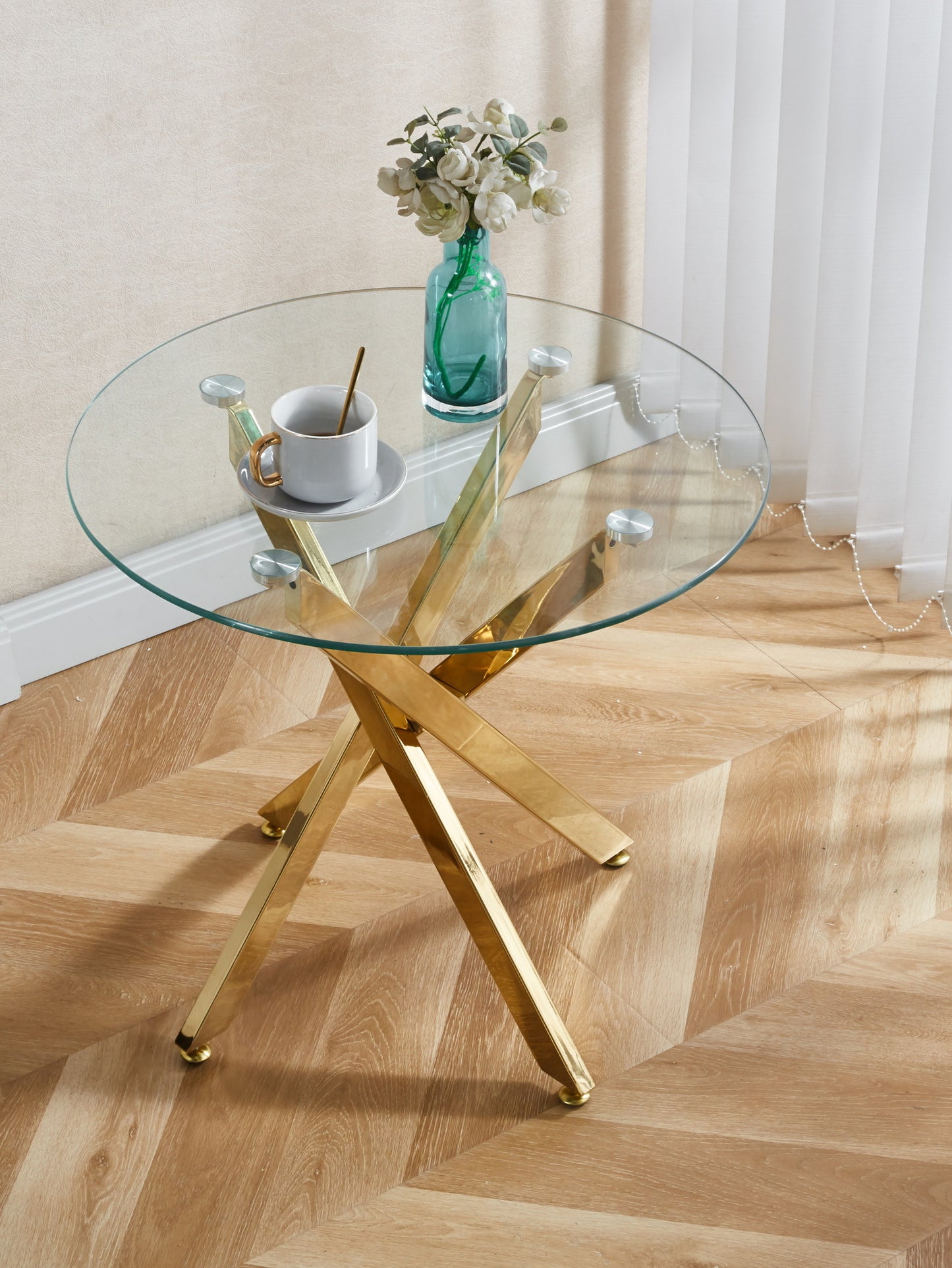 Modern round glass coffee table with polished gold base