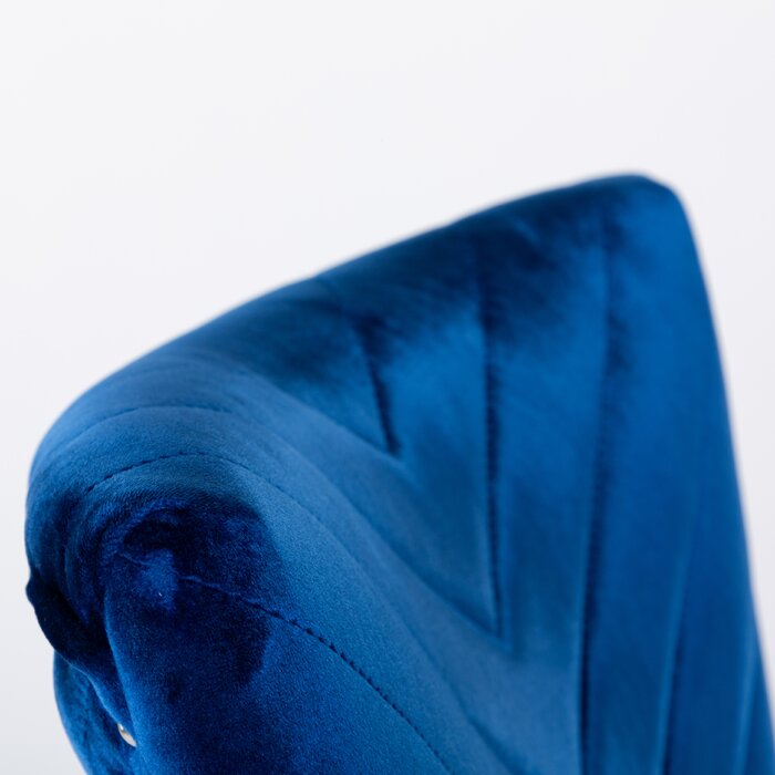 Closeup of quilted royal blue velvet dining chair back