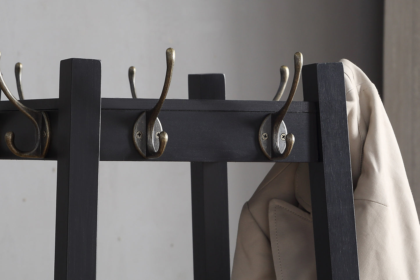 Dark gray wooden hall tree with antique brass hooks