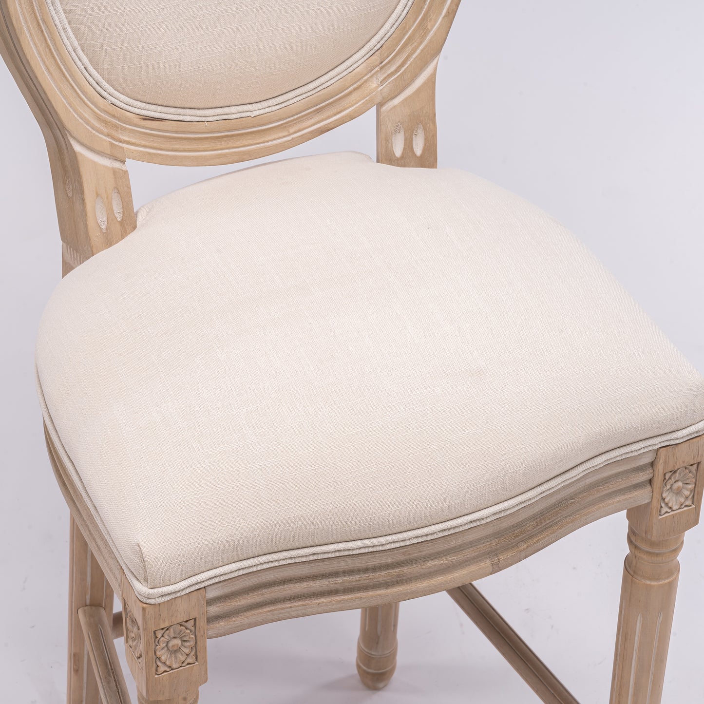 Light beige linen upholstered dining chair with carved wood frame