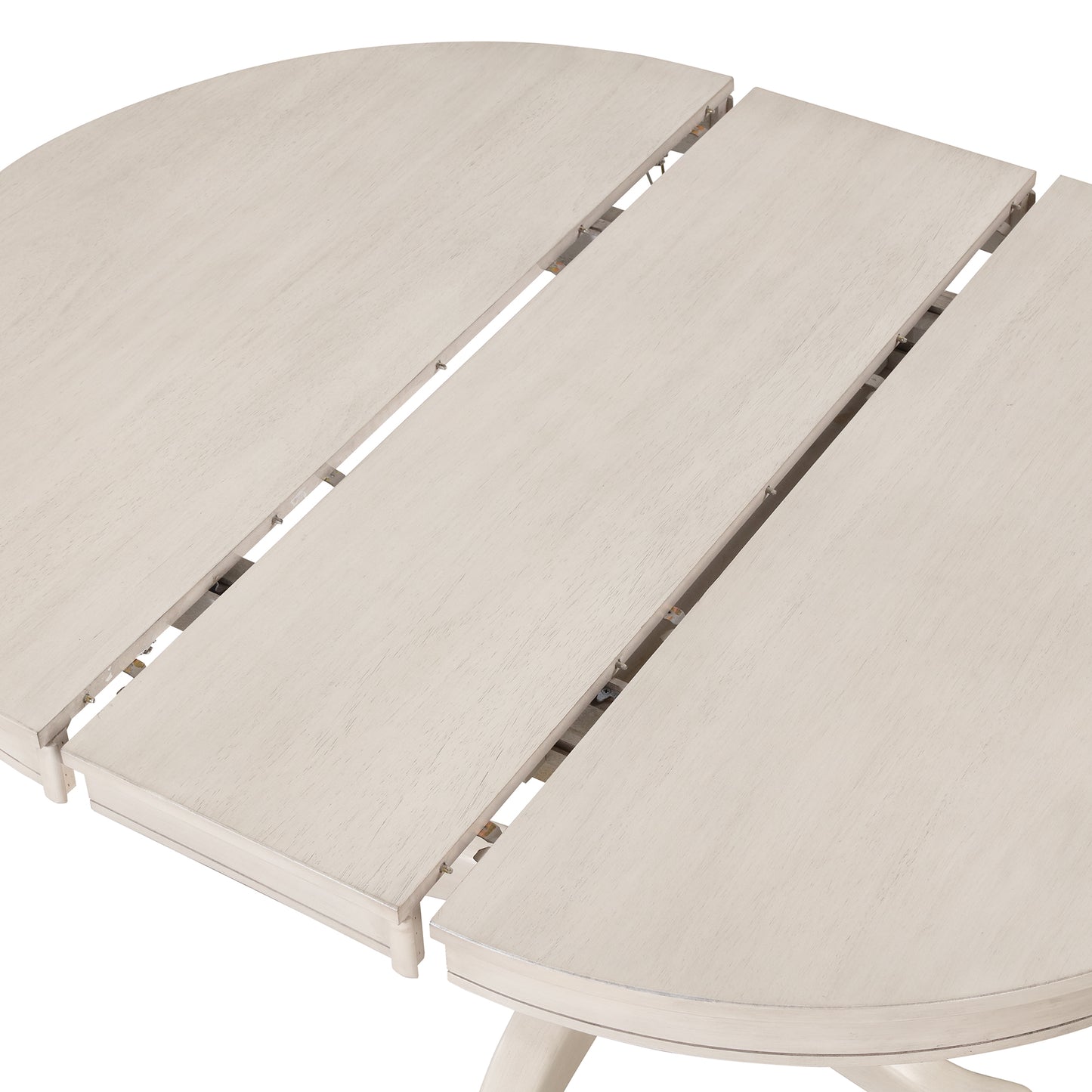 Closeup of a distressed white extendable dining table showing wood grain texture