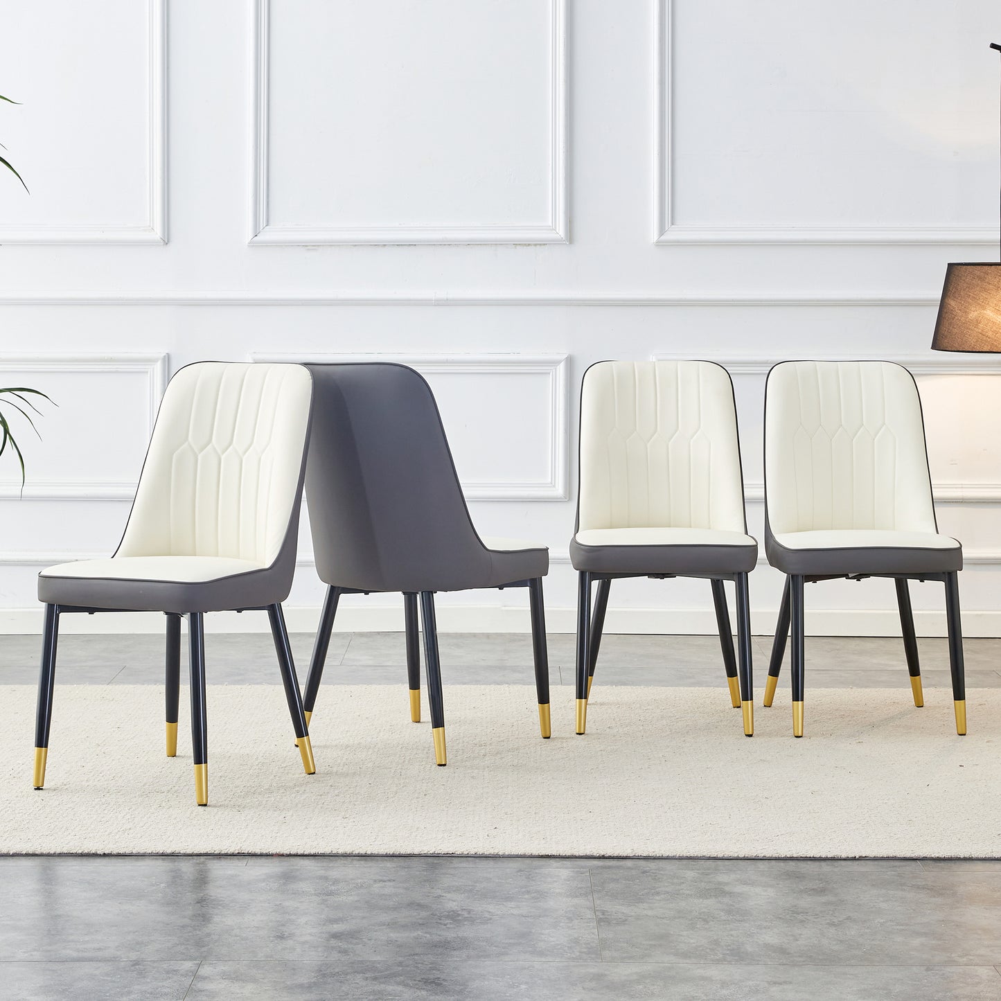 Set of four modern dining chairs with cream upholstered seats and dark gray backs