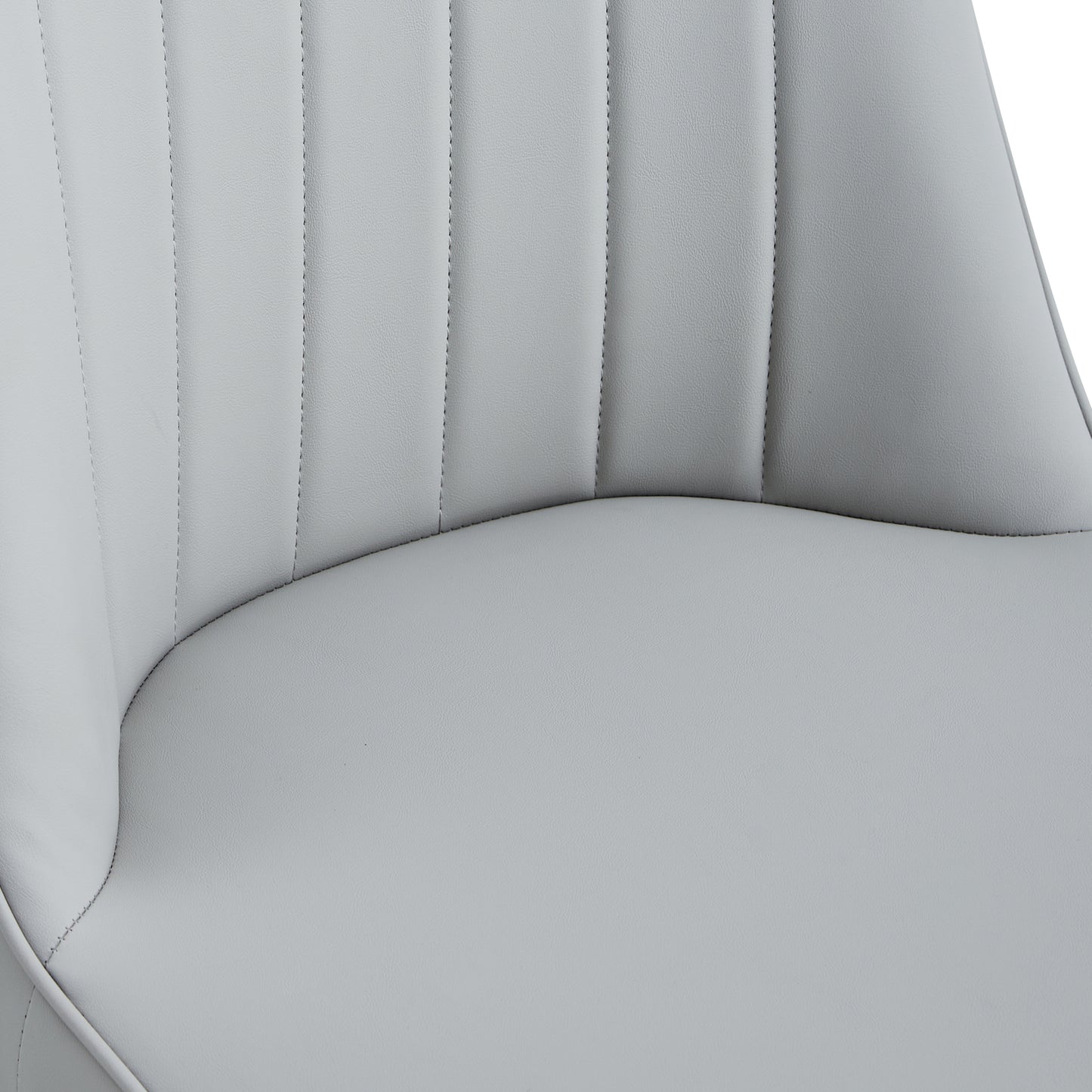 Closeup of light grey faux leather dining chair seat with channel tufting