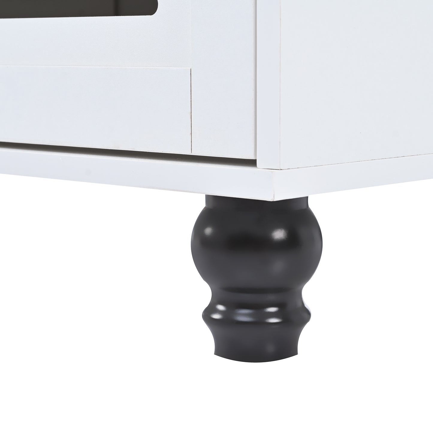 Closeup of a white wooden cabinet with a decorative black turned leg